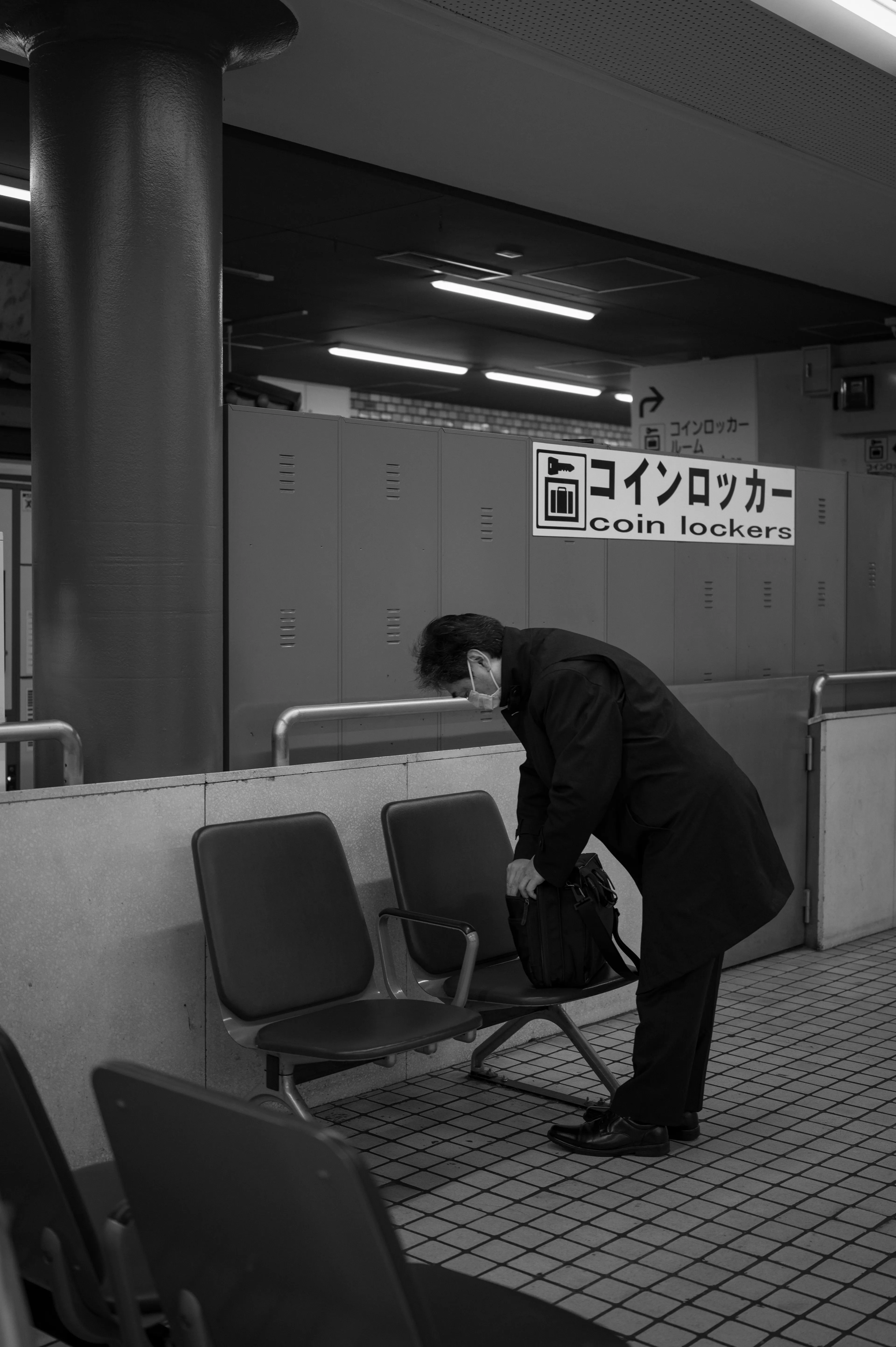 A commuter organizes his work bag before exiting the train station to take on the day ahead.