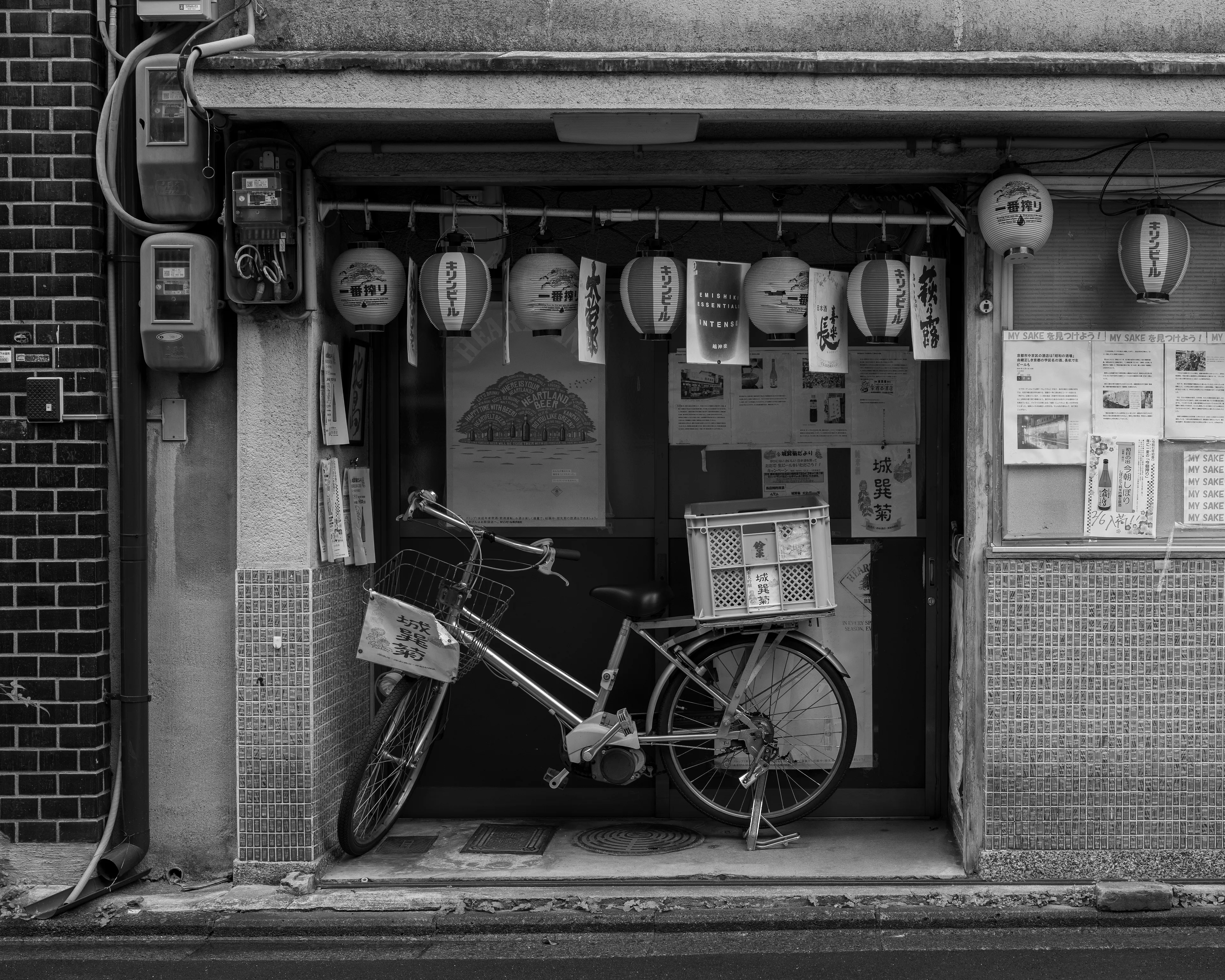 A parked bike, blocking the entrance of a bar, not yet open for the day.