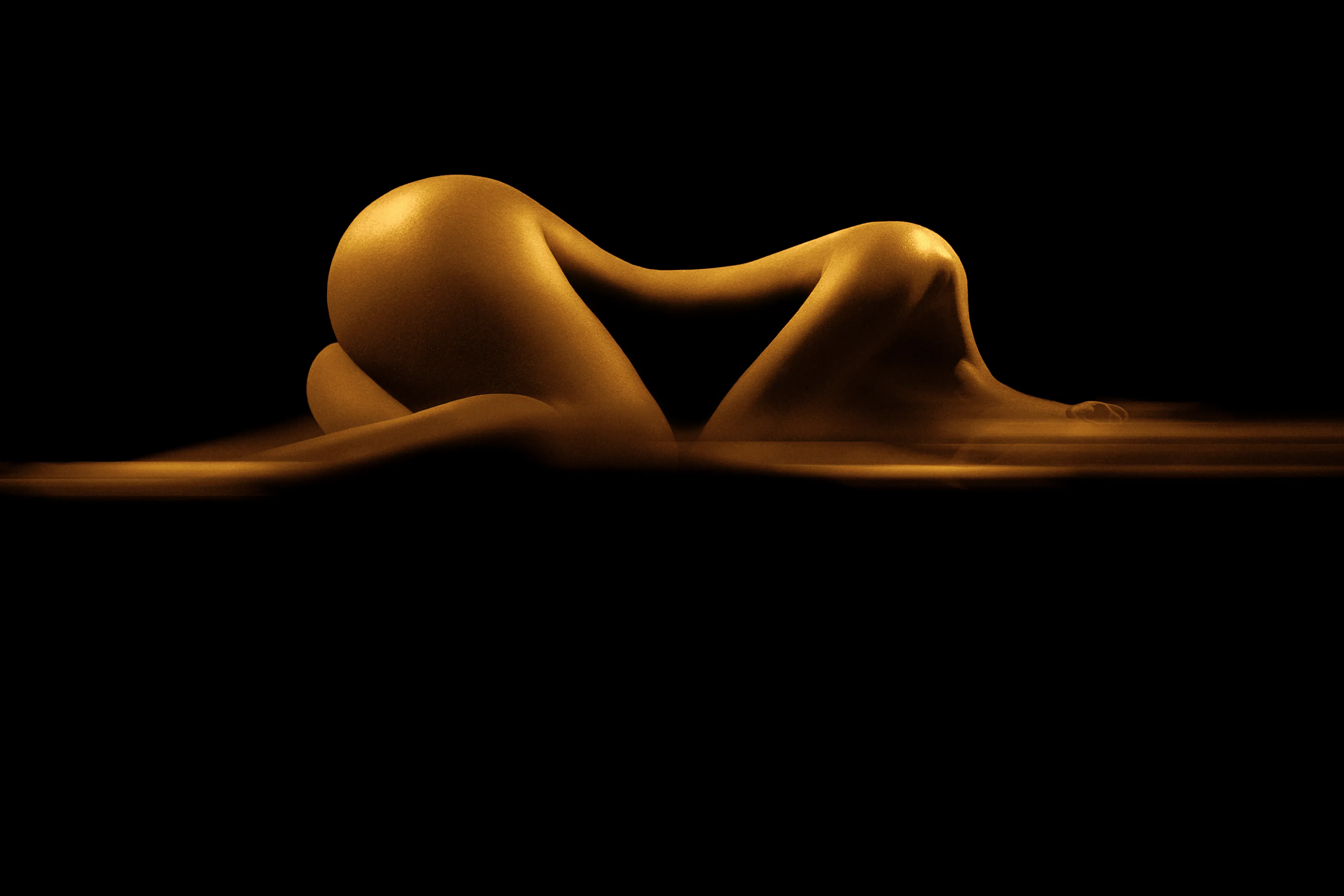 A beautiful golden shape of a woman.
A nude art photography.