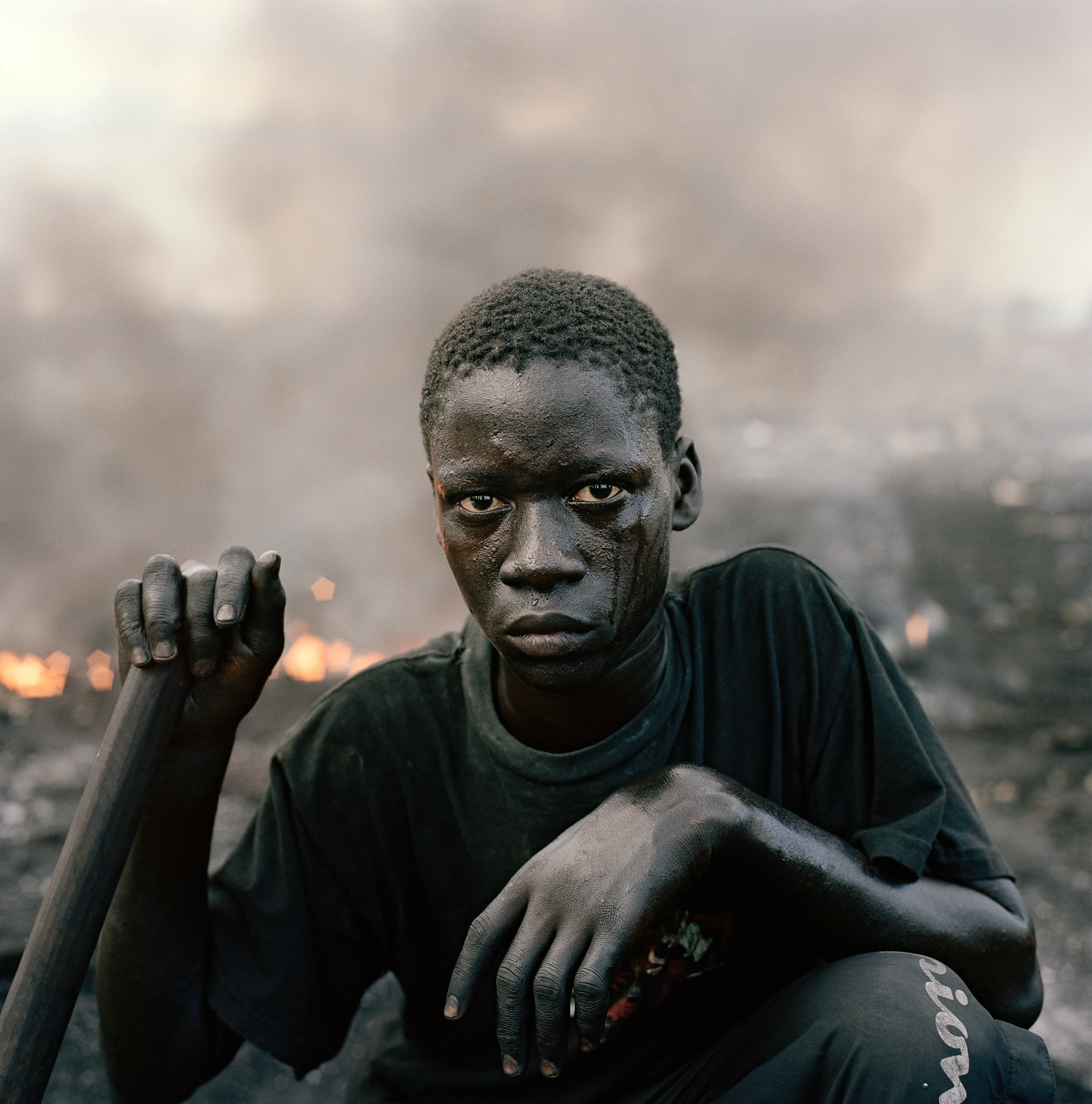 "This essay was photographed on a densely populated triangle of land in the Ghanaian capital of Accra. Bounded by the Abossey Okai Road and Odaw River, a polluted waterway that flows into the Korle Lagoon, Agbogbloshie is the second largest e-waste processing area in West Africa. It abuts Old Fadama, an impoverished settlement that offers northern migrants to the city the cheapest rents and a convenient base close to the central markets, a major employer. Home to an estimated 80 000 inhabitants, this mixed-used area on a former wetland consists not only of formal and informal residences for disenfranchised migrants to the city, but a commercial bus depot, and a vast and differentiated marketplace that includes specialised e-waste markets. An irregular activity until a few years ago, large volumes of end-of-life computers and television are now handled by Ghana’s port daily. Shipped under pretext of being reusable electronic goods, items that are not saleable end up at Agbogbloshie, nicknamed by locals as ‘Sodom and Gomorrah’.

It is here that circuits, transistors, capacitors and semiconductors are reduced to their base metals. There is, one has to admit, something beautifully alchemical about what’s happening there: these devices that are the pinnacle of cultural achievement get transformed back into their base elements. Of course, this is the sympathetic reading of an artist. The political ecologist Paul Robbins has described the dump as ‘a bizarre engine that maintains a self-replicating worldwide system of over-production’. I think it is fair to say that Agbogbloshie is a dark and dirty monument to the digital age, to our faith in technology and its built-in obsolescence. This idea of surplus and waste, which is key to our digital experience, is not one that many people seem comfortable addressing. Being in an environment like this, where geopolitical imbalances are being exploited to effectively dump waste on poor countries, it is hard not to take a political position. And so I have let my photographs be used by advocacy groups.

I first encountered the dump in a photograph published by National Geographic. This is a recurrent theme in my photography, how photographs prompt me to make my own photographs. The work was produced during two trips of two weeks each. I tend to photograph over two-week stretches. I find this is a period in which I can keep my eye fresh. After that you become too accustomed to a place. It was something I realised in Rwanda, how quickly one becomes desensitised and acclimatised to completely unacceptable situations, how the mind is capable of this". -  Pieter Hugo

Edition: 1 of 1