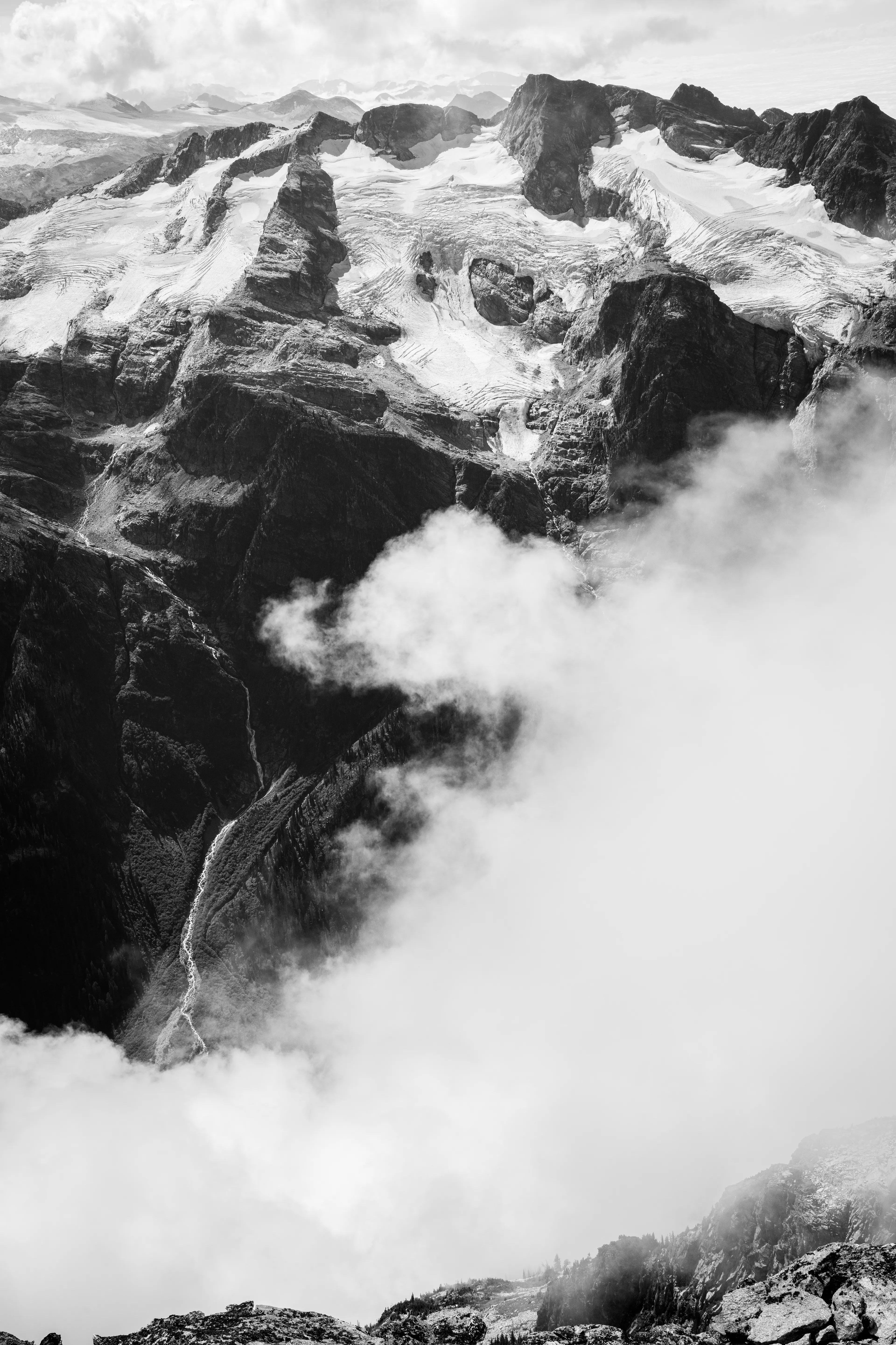 Standing atop that lofty peak, where earth and sky converged in a mystic union, I felt myself suspended between worlds, a solitary figure in communion with the elements. The wind whispered tales of ancient voyages across the rugged terrain, and the vista below unfurled like a boundless ocean of earth's secrets, each contour of the land a chapter in a story as old as time itself.

A photograph by awhurst.  
Edition 1/1.