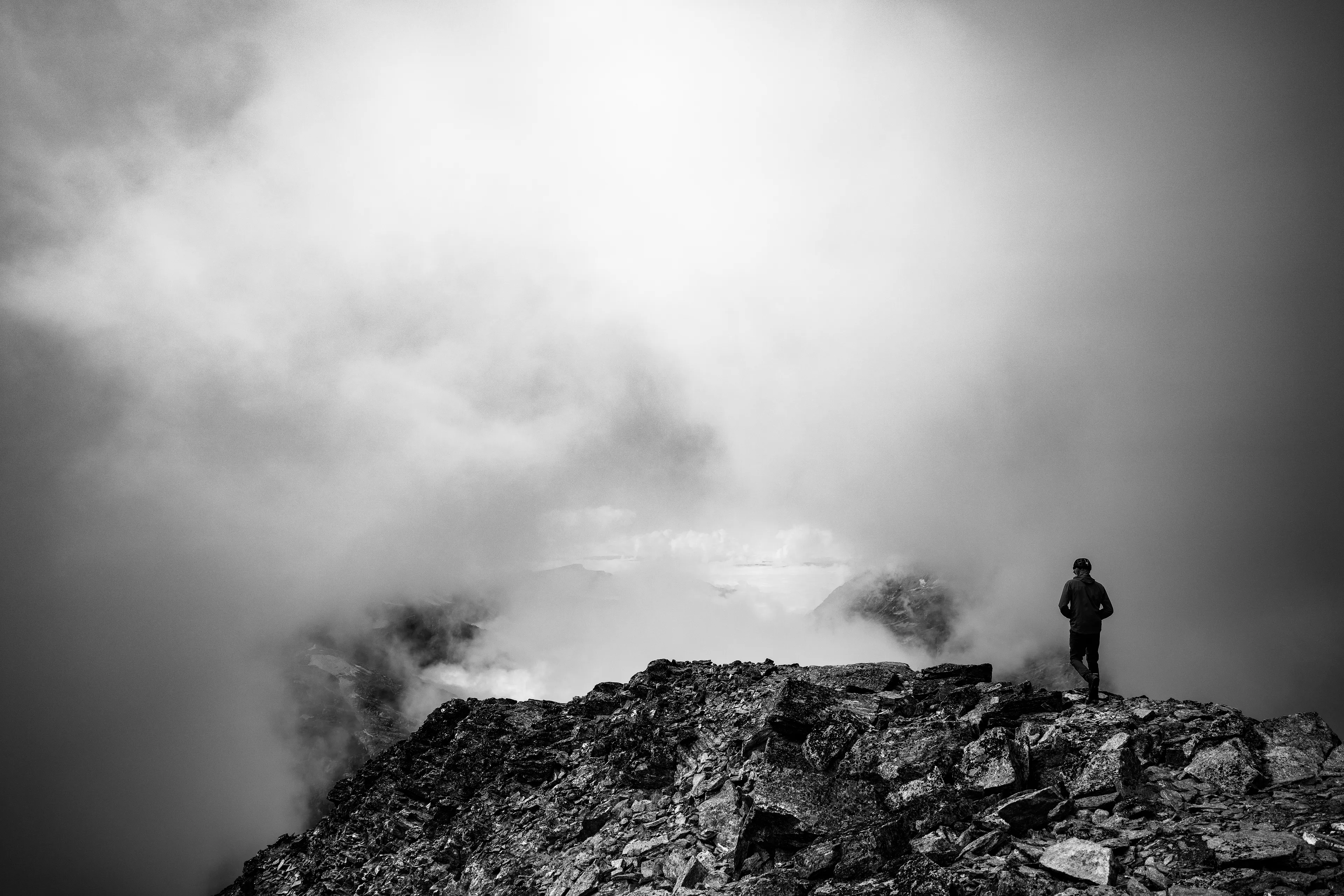 Upon the mountain's lofty crown I stand,  
Enveloped by a shroud of mist and cloud.  
In this celestial realm, I dare to dream,  
Where heaven and earth as one are now endowed.  
Above the world, in silence I survey,  
The realm below, in veiled obscurity.  
O' nature's majesty, in clouds we play,  
A mortal soul, 'midst such immensity.  
Though tempests rage and darkness may descend,  
In cloud-kissed heights, I find my soul's amend.

A photograph by awhurst.  
Edition 1/1.