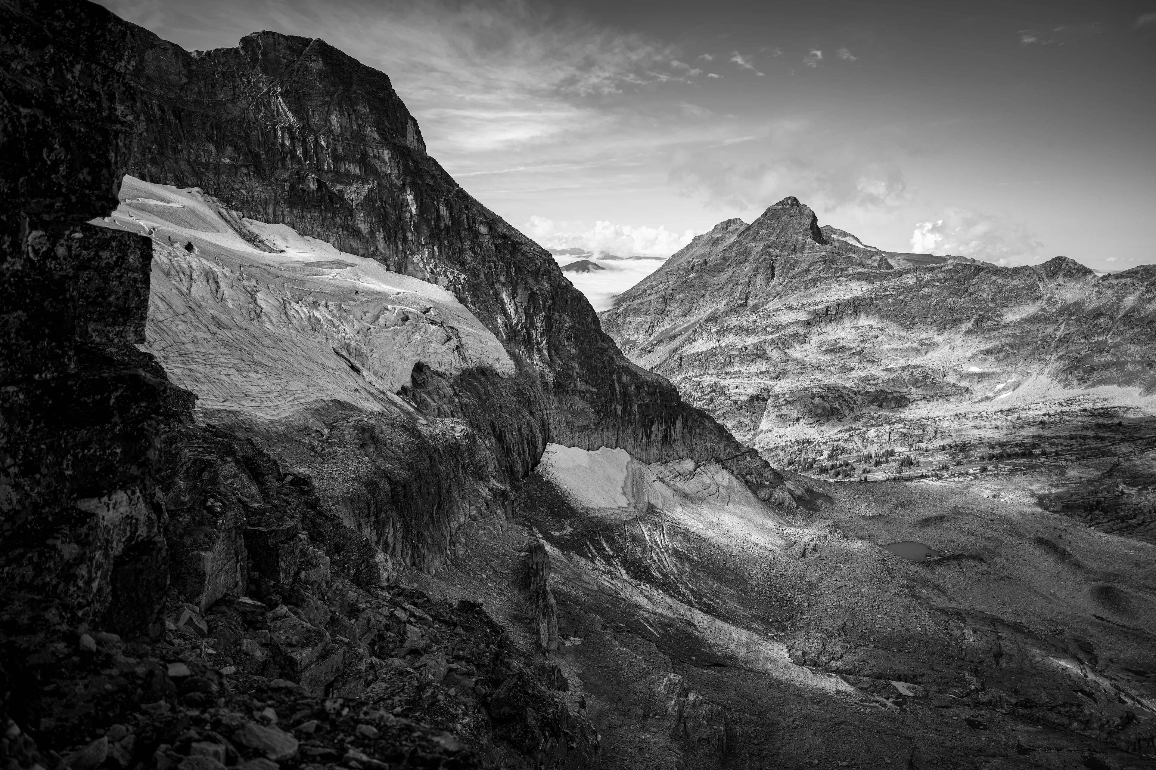 As I stood before the hanging glacier, my heart quickened with a reverence for the timeless spectacle of nature's craftsmanship. The glacier, suspended like a glistening jewel in the serrated embrace of the mountains, exuded an otherworldly beauty. Its frigid contours, sculpted over millennia, captured the ethereal dance of light and ice. I felt an artist's kinship with this frozen behemoth, striving to preserve its essence with my lens while being overcome with a profound sadness over what was to come.

A photograph taken by awhurst.  
Edition 1/1