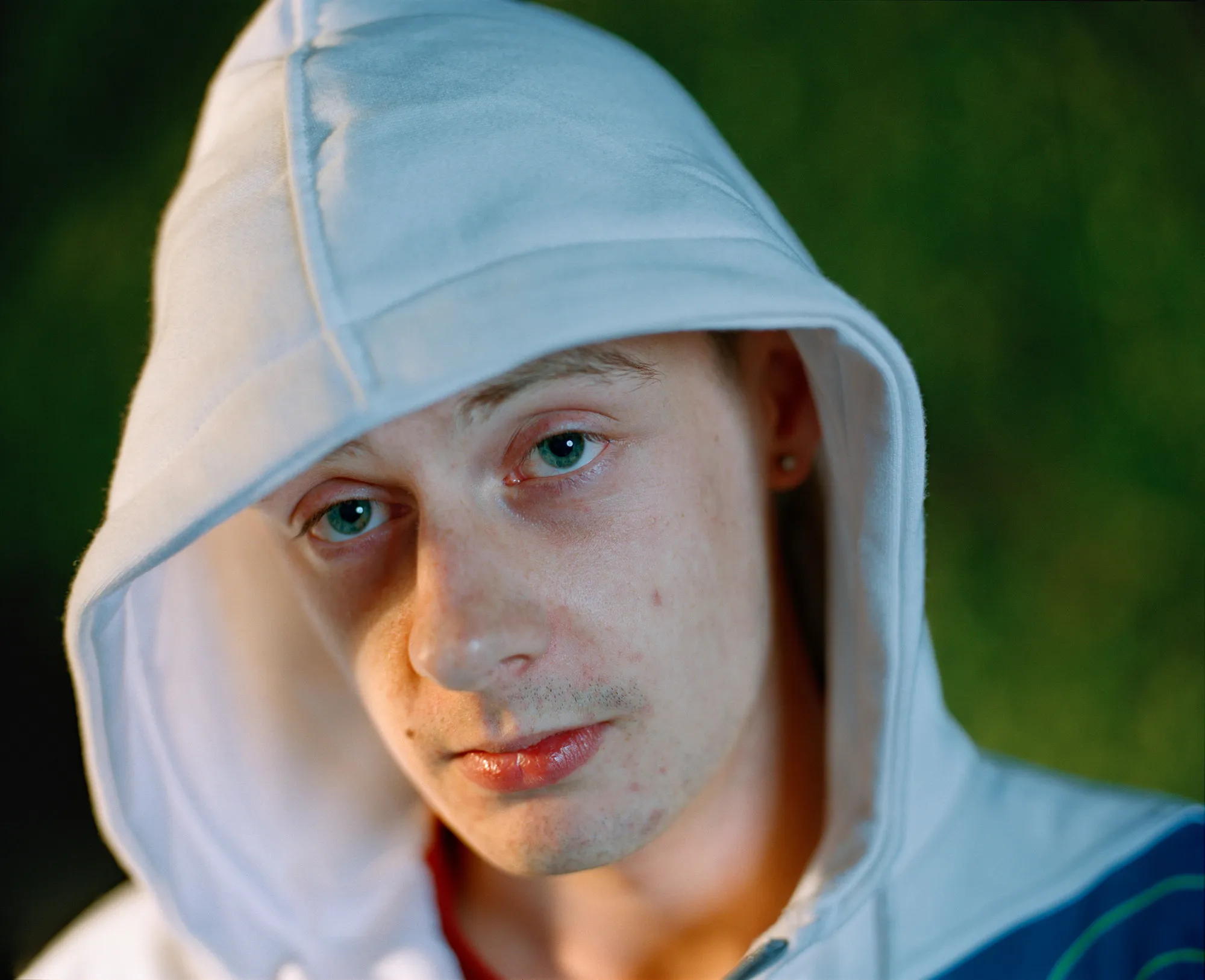 Image caption: White hoodies were everywhere in 2012.

Assembly and Sasha Wolf Projects present “My Last Day at Seventeen,” the genesis NFT collection by an American photographer Doug DuBois. Combining portraits, spontaneous encounters and collaborative performances, the images in "My Last Day at Seventeen" hover between documentary and fiction. Doug DuBois was first introduced to a group of teenagers from the Russell Heights housing estate while he was an artist-in-residence in Cobh, on the southwest coast of Ireland. He was fascinated by the insular neighborhood, in which "everyone seems to be someone's cousin, former girlfriend, or spouse." DuBois gained entry when two participants of a workshop he taught took him to a local hangout spot, opening his eyes to a world of not-quite-adults, struggling through the last days of their childhood. Over the course of five years, DuBois returned to Russell Heights examining the uncertainties of growing up in Ireland today while highlighting the unique relationship between artist and subject.

Doug Dubois is a widely-exhibited American photographer well known for capturing intimate familial scenes. His photographs are in the collection of the Museum of Modern Art in NY; SFMOMA in San Francisco; J. Paul Getty Museum and LACMA in Los Angeles; The Museum of Fine Art in Houston; the Library of Congress in Washington DC; and the Victoria and Albert Museum, London.