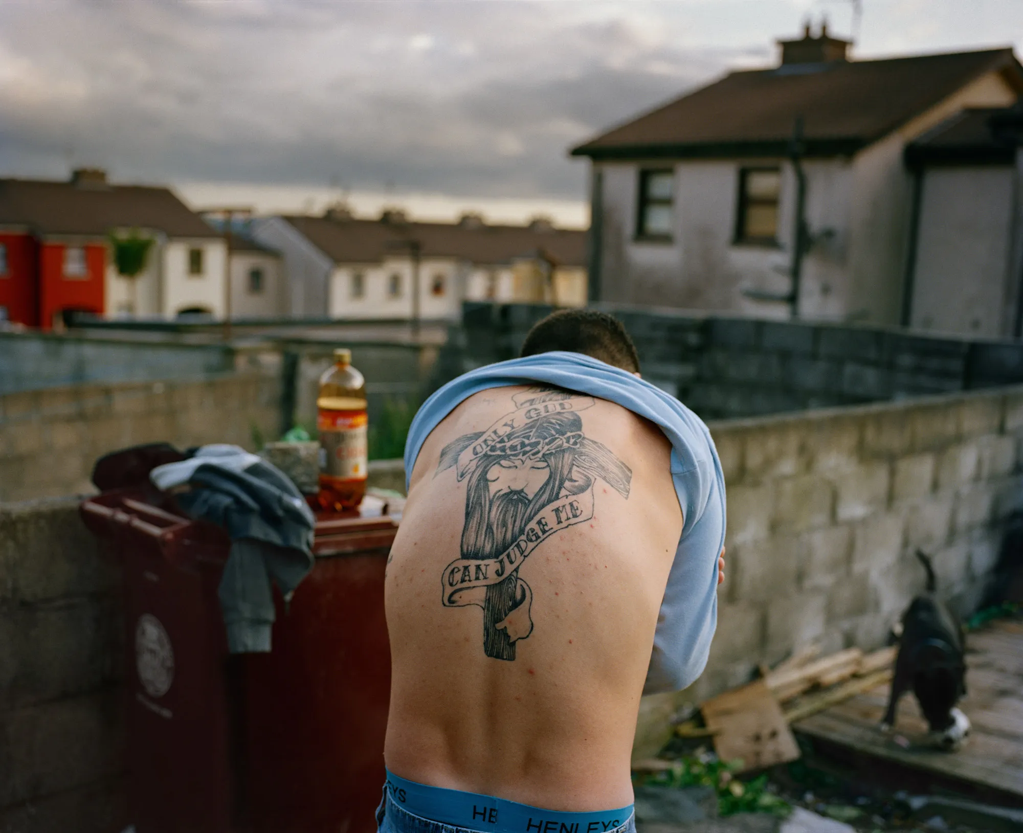 Image caption: Kevin turned 18 during my first summer in Cobh. At his party, Kevin’s brother Dean—a big, sweetheart of a man, showed me his tat, recently inked and not quite finished.

Assembly and Sasha Wolf Projects present “My Last Day at Seventeen,” the genesis NFT collection by an American photographer Doug DuBois. Combining portraits, spontaneous encounters and collaborative performances, the images in "My Last Day at Seventeen" hover between documentary and fiction. Doug DuBois was first introduced to a group of teenagers from the Russell Heights housing estate while he was an artist-in-residence in Cobh, on the southwest coast of Ireland. He was fascinated by the insular neighborhood, in which "everyone seems to be someone's cousin, former girlfriend, or spouse." DuBois gained entry when two participants of a workshop he taught took him to a local hangout spot, opening his eyes to a world of not-quite-adults, struggling through the last days of their childhood. Over the course of five years, DuBois returned to Russell Heights examining the uncertainties of growing up in Ireland today while highlighting the unique relationship between artist and subject.

Doug Dubois is a widely-exhibited American photographer well known for capturing intimate familial scenes. His photographs are in the collection of the Museum of Modern Art in NY; SFMOMA in San Francisco; J. Paul Getty Museum and LACMA in Los Angeles; The Museum of Fine Art in Houston; the Library of Congress in Washington DC; and the Victoria and Albert Museum, London.