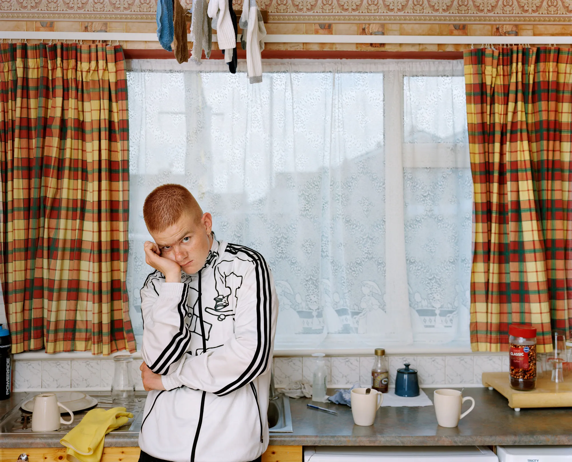 Image caption: Padjoe lived with his father who kept their home meticulously clean and ordered. Padjoe had just returned from the dentist and was cradling a busted molar.

Assembly and Sasha Wolf Projects present “My Last Day at Seventeen,” the genesis NFT collection by an American photographer Doug DuBois. Combining portraits, spontaneous encounters and collaborative performances, the images in "My Last Day at Seventeen" hover between documentary and fiction. Doug DuBois was first introduced to a group of teenagers from the Russell Heights housing estate while he was an artist-in-residence in Cobh, on the southwest coast of Ireland. He was fascinated by the insular neighborhood, in which "everyone seems to be someone's cousin, former girlfriend, or spouse." DuBois gained entry when two participants of a workshop he taught took him to a local hangout spot, opening his eyes to a world of not-quite-adults, struggling through the last days of their childhood. Over the course of five years, DuBois returned to Russell Heights examining the uncertainties of growing up in Ireland today while highlighting the unique relationship between artist and subject.

Doug Dubois is a widely-exhibited American photographer well known for capturing intimate familial scenes. His photographs are in the collection of the Museum of Modern Art in NY; SFMOMA in San Francisco; J. Paul Getty Museum and LACMA in Los Angeles; The Museum of Fine Art in Houston; the Library of Congress in Washington DC; and the Victoria and Albert Museum, London.