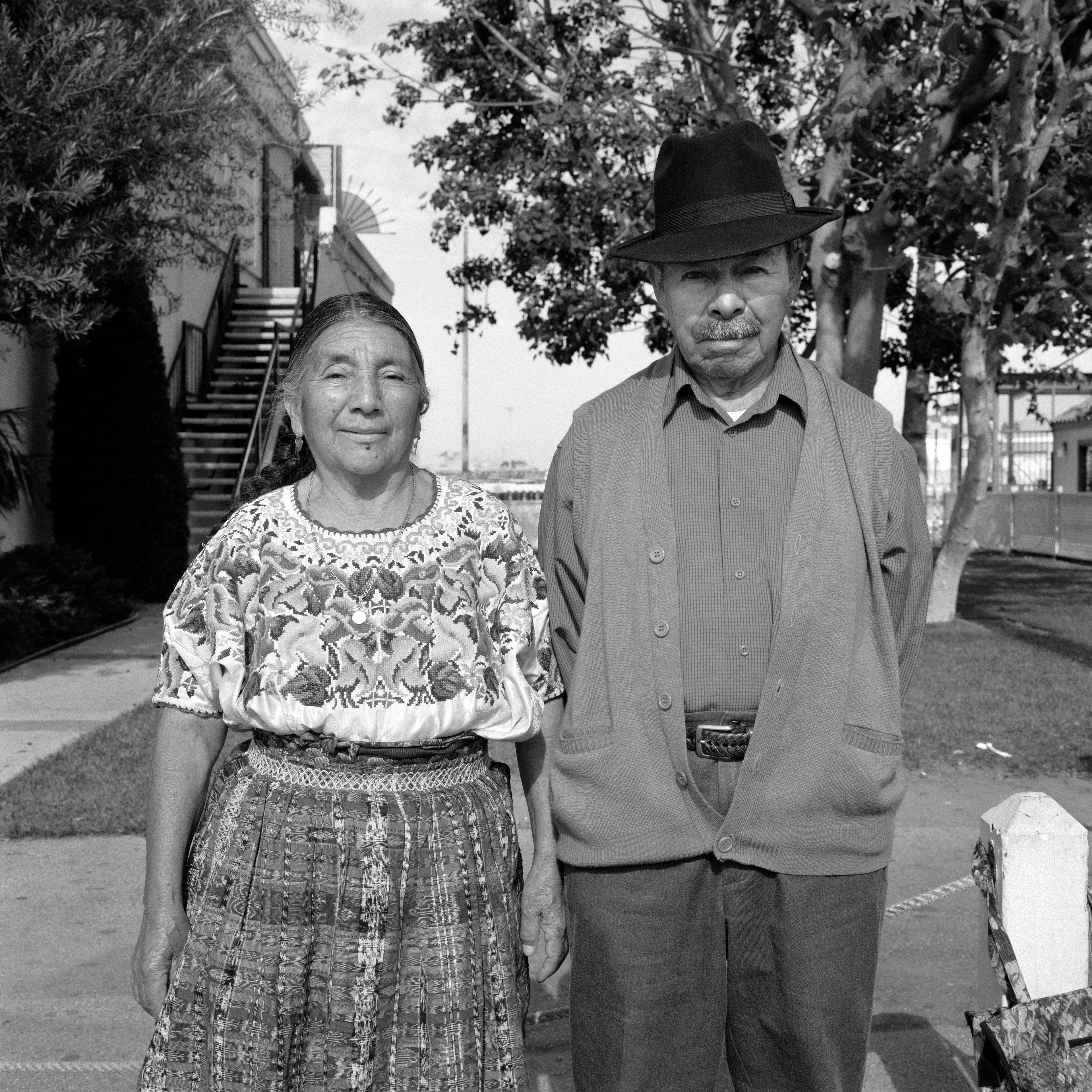 THE VILLAGE #18 PORTRAIT OF A COUPLE by Deanna Templeton

This project started in 2002. A year after my mother passed away, a few years after my father passed. What I remember was one day I was thinking about my parents and feeling a little bit lonely, a little empty and decided to go for a drive. So I decided to drive out to my grandmother's house in San Pedro, which is about a 45 minute drive from where I live. I just wanted to reminisce, to re-explore the surroundings where I would go when I was a child. The liquor store I would walk to to get a Lipton Ice Tea and a bag of Frito’s, to the bakery where I swore all the cookies didn’t have sugar in them and then I drove over to Ports O’Call Village. As soon as I started to walk around I came across a stage with some Mariachis playing and it just hit me, I felt like I was home, I was with family. Over the next 5 years, whenever I could, I started going out there on the weekends. Getting reacquainted with the village and the locals. To shoot everything I wanted to remember.

Edition: 1 of 1

Commissioned by Obscura