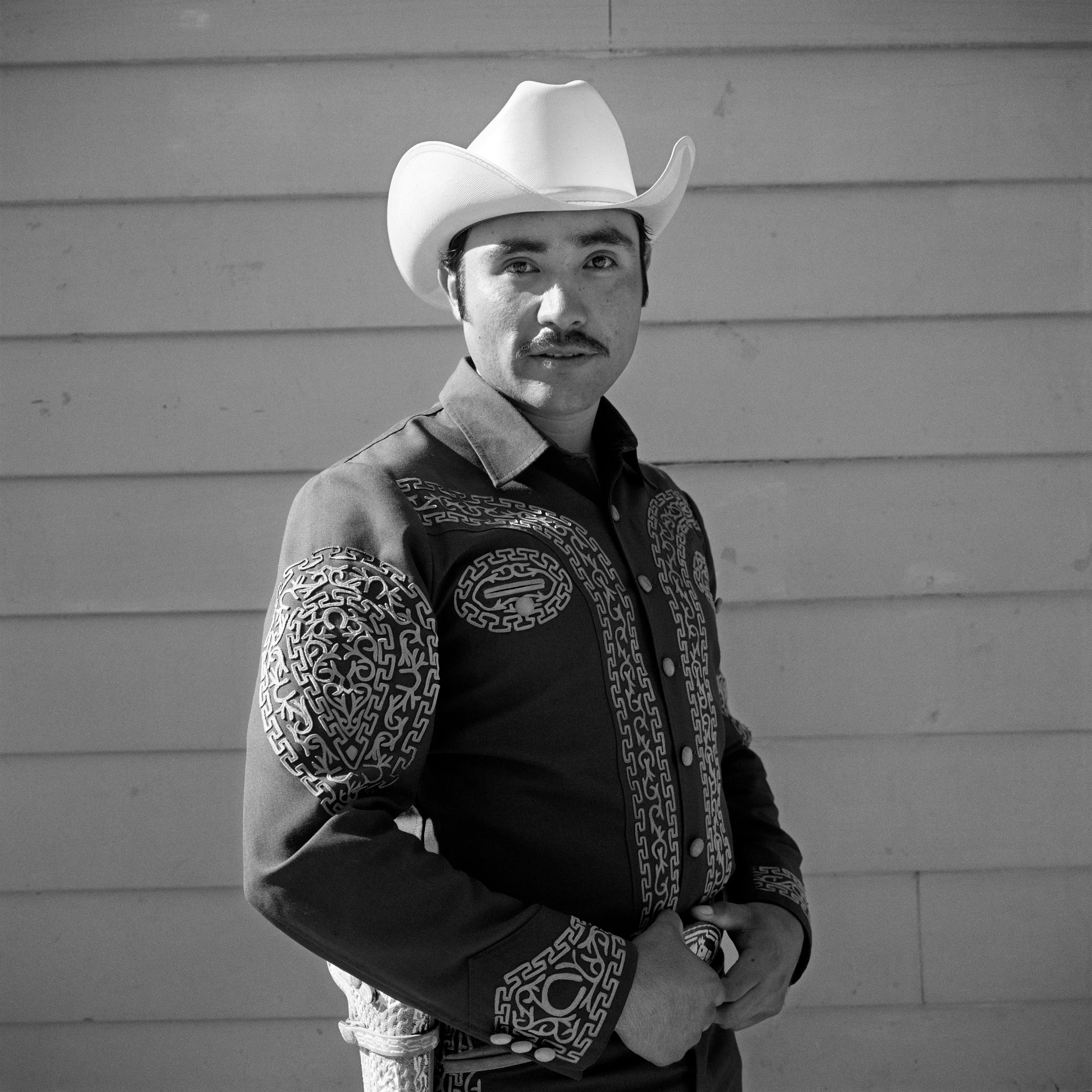 THE VILLAGE #22 PORTRAIT OF A MAN IN A COWBOY HAT by Deanna Templeton

This project started in 2002. A year after my mother passed away, a few years after my father passed. What I remember was one day I was thinking about my parents and feeling a little bit lonely, a little empty and decided to go for a drive. So I decided to drive out to my grandmother's house in San Pedro, which is about a 45 minute drive from where I live. I just wanted to reminisce, to re-explore the surroundings where I would go when I was a child. The liquor store I would walk to to get a Lipton Ice Tea and a bag of Frito’s, to the bakery where I swore all the cookies didn’t have sugar in them and then I drove over to Ports O’Call Village. As soon as I started to walk around I came across a stage with some Mariachis playing and it just hit me, I felt like I was home, I was with family. Over the next 5 years, whenever I could, I started going out there on the weekends. Getting reacquainted with the village and the locals. To shoot everything I wanted to remember.

Edition: 1 of 1

Commissioned by Obscura