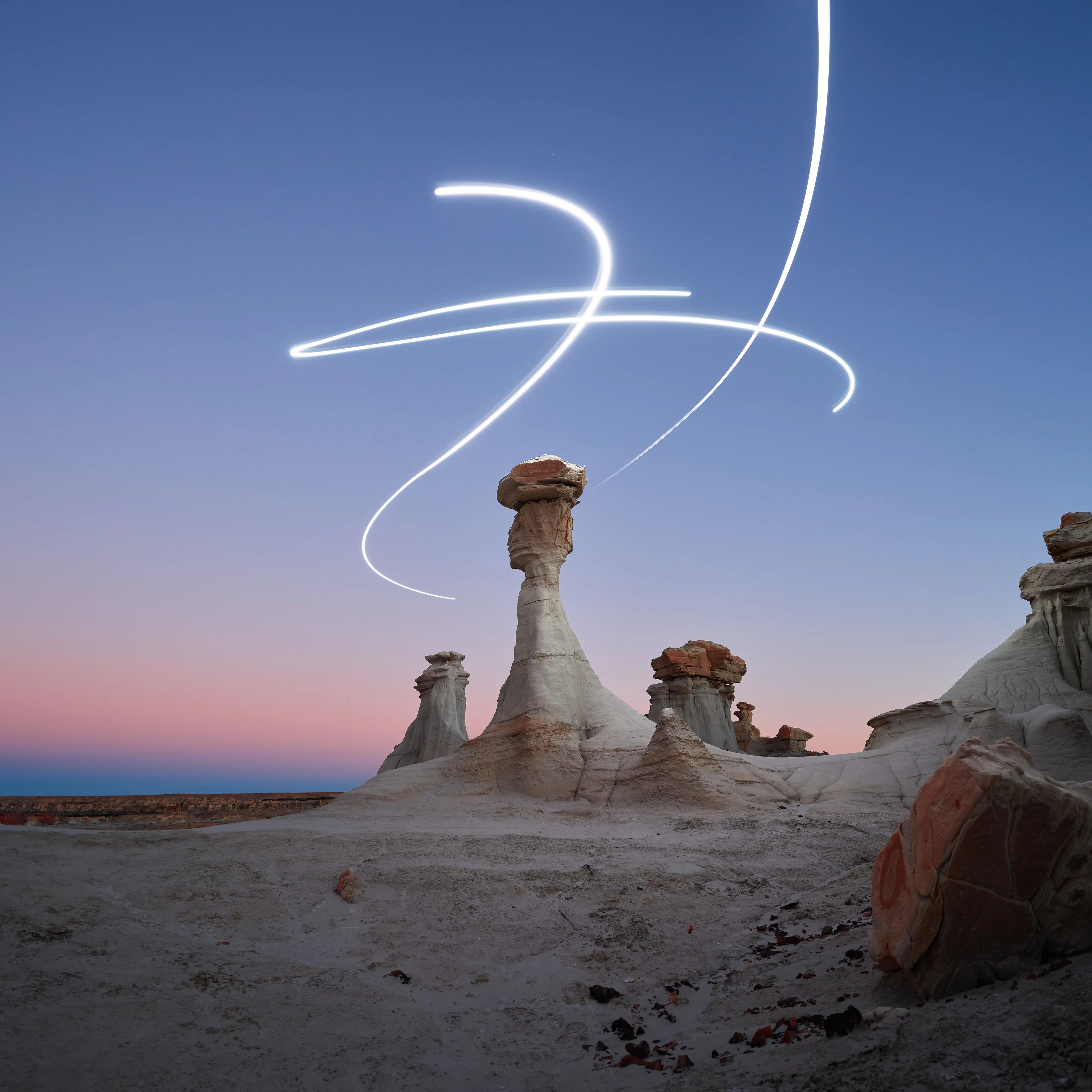 Aeroglyph Variations #17 by Reuben Wu

Aeroglyph Variations is a collection evolved from my Aeroglyphs body of work, created exclusively for Obscura Curated. 

Aeroglyphs explores my method of intervention in landscape photography. By using light carrying drones and long exposure, I’m able to play a larger role in artistic expression all without leaving a trace on the scene.

This series was captured over the course of 20 hours in New Mexico, USA on Dec 12-13 2021. It shows the iterative processes and decisions I typically encounter during the creation of a final image, presented as a collection of 55 images. Compositionally, every image is the same, yet in attributes, every image is different. Time of day, light formations (glyphs) and other traits vary within the series to result in a spectrum of unique possibilities.

Taking inspiration from generative art and groundbreaking photo projects such as Carpoolers (Alejandro Cartagena), this project examines the notion of the photographer as algorithm; the code that creates and which ultimately derives from our unique programming of life experiences.
Reuben Wu's OpenSea: https://opensea.io/itsreuben?tab=created

Edition: 1 of 1

Commissioned by Obscura