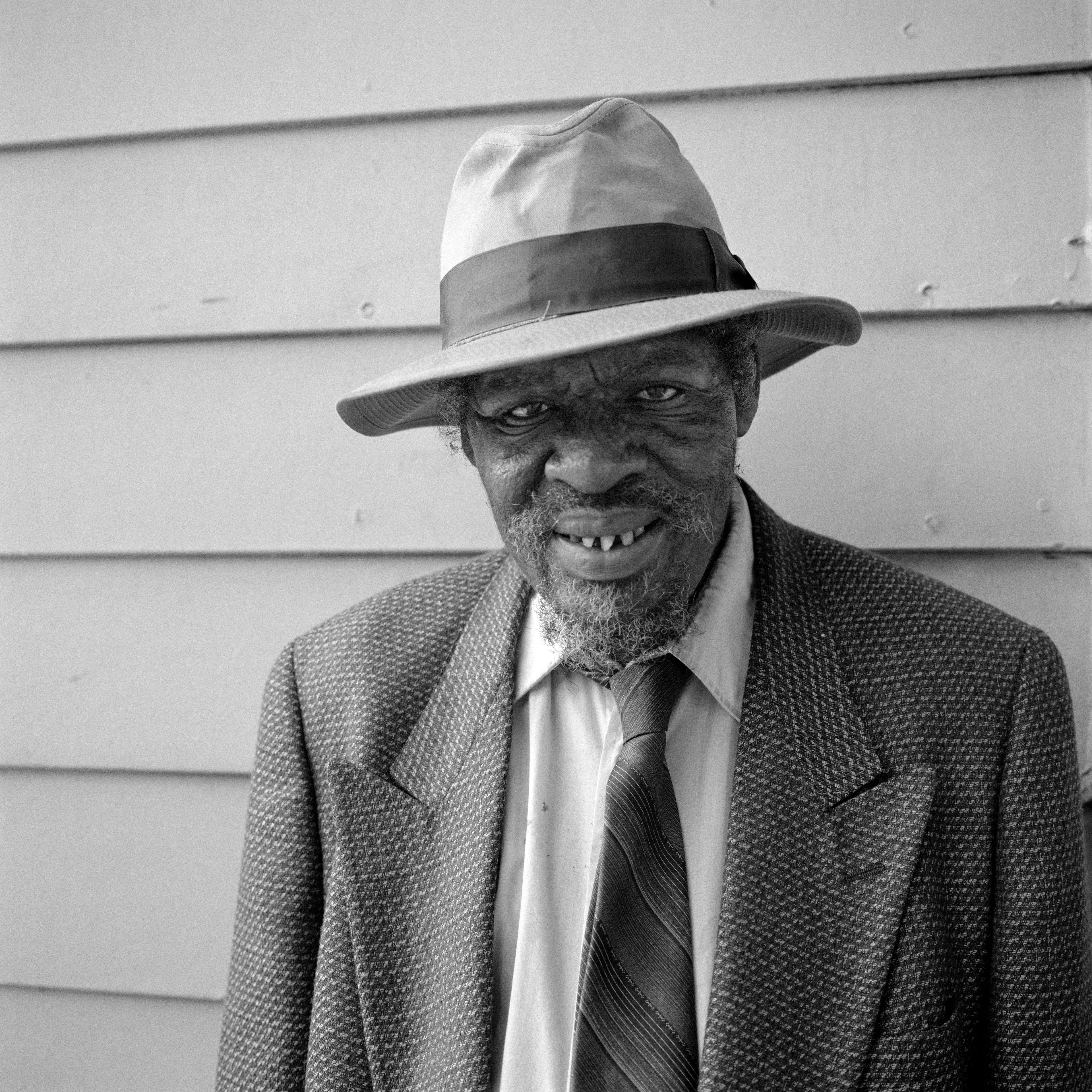THE VILLAGE #38 PORTRAIT OF A MAN IN A FEDORA by Deanna Templeton

This project started in 2002. A year after my mother passed away, a few years after my father passed. What I remember was one day I was thinking about my parents and feeling a little bit lonely, a little empty and decided to go for a drive. So I decided to drive out to my grandmother's house in San Pedro, which is about a 45 minute drive from where I live. I just wanted to reminisce, to re-explore the surroundings where I would go when I was a child. The liquor store I would walk to to get a Lipton Ice Tea and a bag of Frito’s, to the bakery where I swore all the cookies didn’t have sugar in them and then I drove over to Ports O’Call Village. As soon as I started to walk around I came across a stage with some Mariachis playing and it just hit me, I felt like I was home, I was with family. Over the next 5 years, whenever I could, I started going out there on the weekends. Getting reacquainted with the village and the locals. To shoot everything I wanted to remember.

Edition: 1 of 1

Commissioned by Obscura