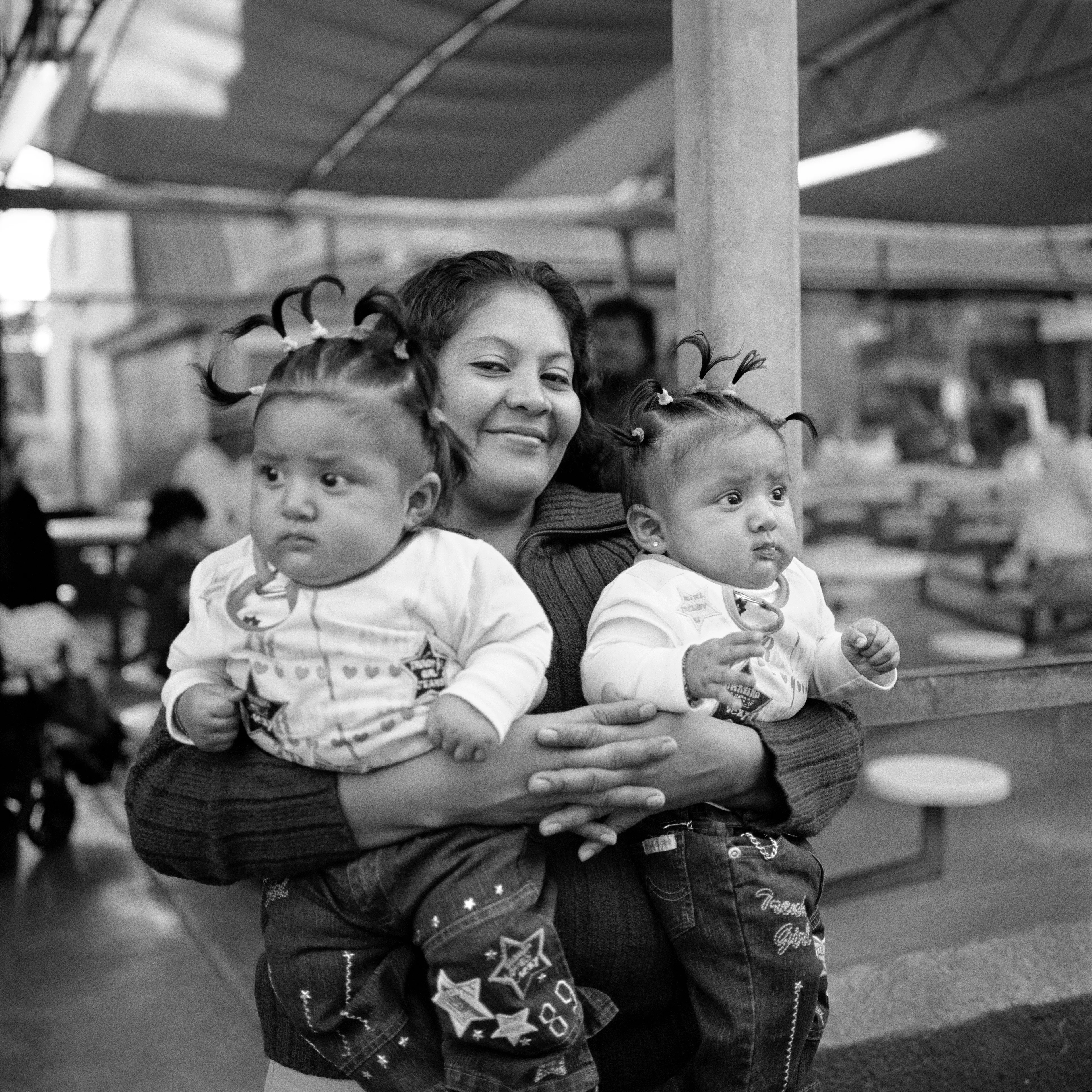 THE VILLAGE #3 MOTHER WITH TWINS by Deanna Templeton

This project started in 2002. A year after my mother passed away, a few years after my father passed. What I remember was one day I was thinking about my parents and feeling a little bit lonely, a little empty and decided to go for a drive. So I decided to drive out to my grandmother's house in San Pedro, which is about a 45 minute drive from where I live. I just wanted to reminisce, to re-explore the surroundings where I would go when I was a child. The liquor store I would walk to to get a Lipton Ice Tea and a bag of Frito’s, to the bakery where I swore all the cookies didn’t have sugar in them and then I drove over to Ports O’Call Village. As soon as I started to walk around I came across a stage with some Mariachis playing and it just hit me, I felt like I was home, I was with family. Over the next 5 years, whenever I could, I started going out there on the weekends. Getting reacquainted with the village and the locals. To shoot everything I wanted to remember.

Edition: 1 of 1

Commissioned by Obscura