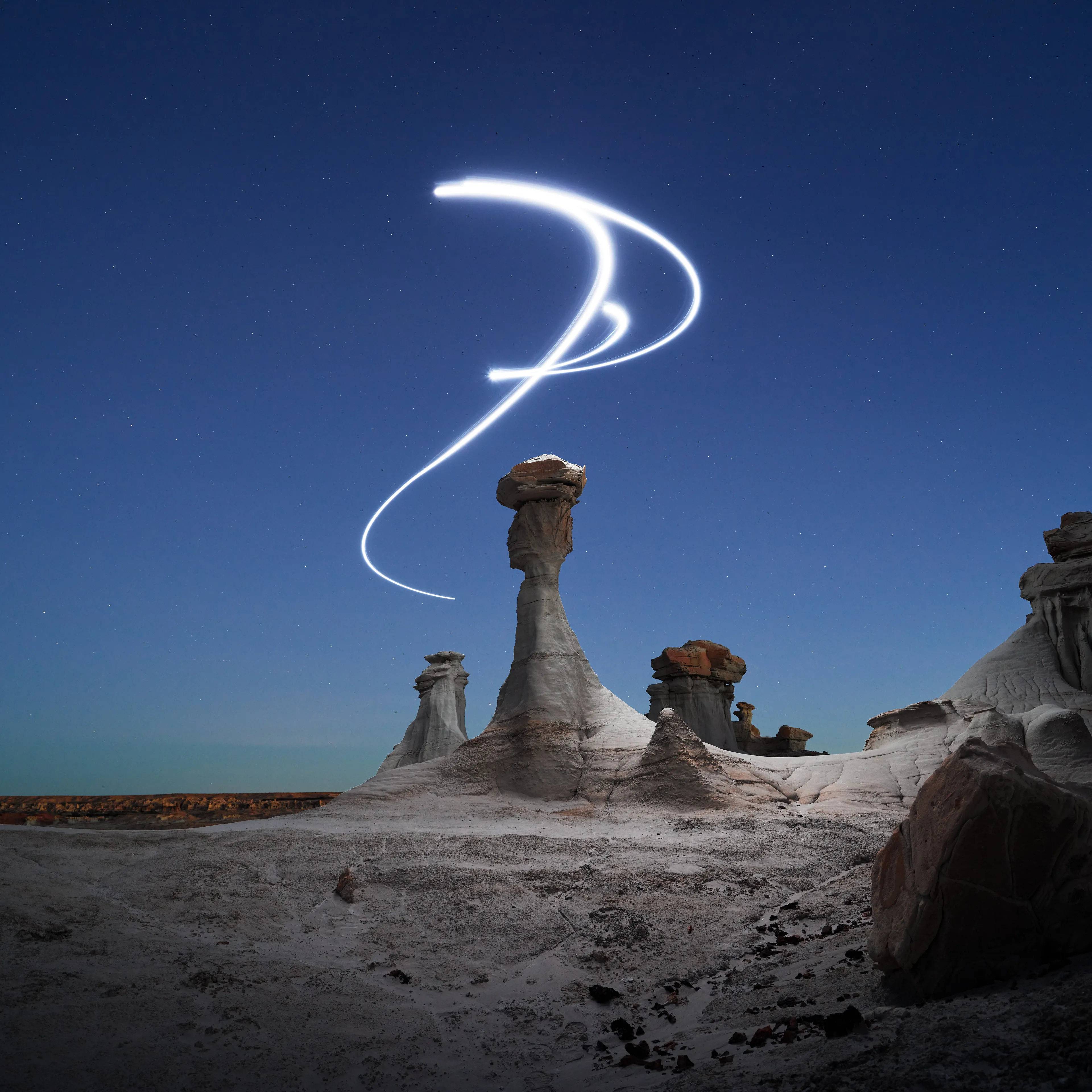 Aeroglyph Variations #10 by Reuben Wu

Aeroglyph Variations is a collection evolved from my Aeroglyphs body of work, created exclusively for Obscura Curated. 

Aeroglyphs explores my method of intervention in landscape photography. By using light carrying drones and long exposure, I’m able to play a larger role in artistic expression all without leaving a trace on the scene.

This series was captured over the course of 20 hours in New Mexico, USA on Dec 12-13 2021. It shows the iterative processes and decisions I typically encounter during the creation of a final image, presented as a collection of 55 images. Compositionally, every image is the same, yet in attributes, every image is different. Time of day, light formations (glyphs) and other traits vary within the series to result in a spectrum of unique possibilities.

Taking inspiration from generative art and groundbreaking photo projects such as Carpoolers (Alejandro Cartagena), this project examines the notion of the photographer as algorithm; the code that creates and which ultimately derives from our unique programming of life experiences.
Reuben Wu's OpenSea: https://opensea.io/itsreuben?tab=created

Edition: 1 of 1

Commissioned by Obscura