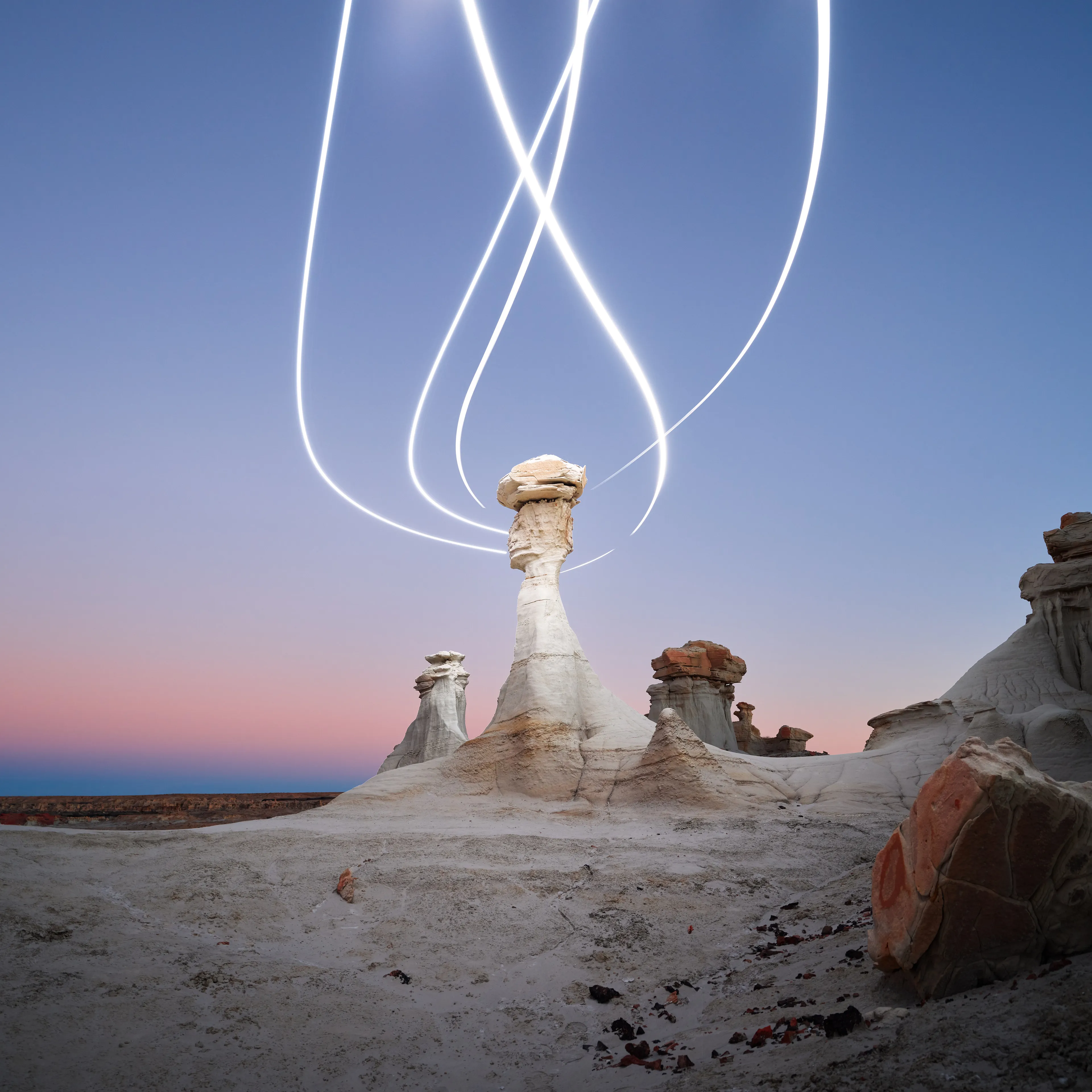 Aeroglyph Variations #18 by Reuben Wu

Aeroglyph Variations is a collection evolved from my Aeroglyphs body of work, created exclusively for Obscura Curated. 

Aeroglyphs explores my method of intervention in landscape photography. By using light carrying drones and long exposure, I’m able to play a larger role in artistic expression all without leaving a trace on the scene.

This series was captured over the course of 20 hours in New Mexico, USA on Dec 12-13 2021. It shows the iterative processes and decisions I typically encounter during the creation of a final image, presented as a collection of 55 images. Compositionally, every image is the same, yet in attributes, every image is different. Time of day, light formations (glyphs) and other traits vary within the series to result in a spectrum of unique possibilities.

Taking inspiration from generative art and groundbreaking photo projects such as Carpoolers (Alejandro Cartagena), this project examines the notion of the photographer as algorithm; the code that creates and which ultimately derives from our unique programming of life experiences.
Reuben Wu's OpenSea: https://opensea.io/itsreuben?tab=created

Edition: 1 of 1

Commissioned by Obscura