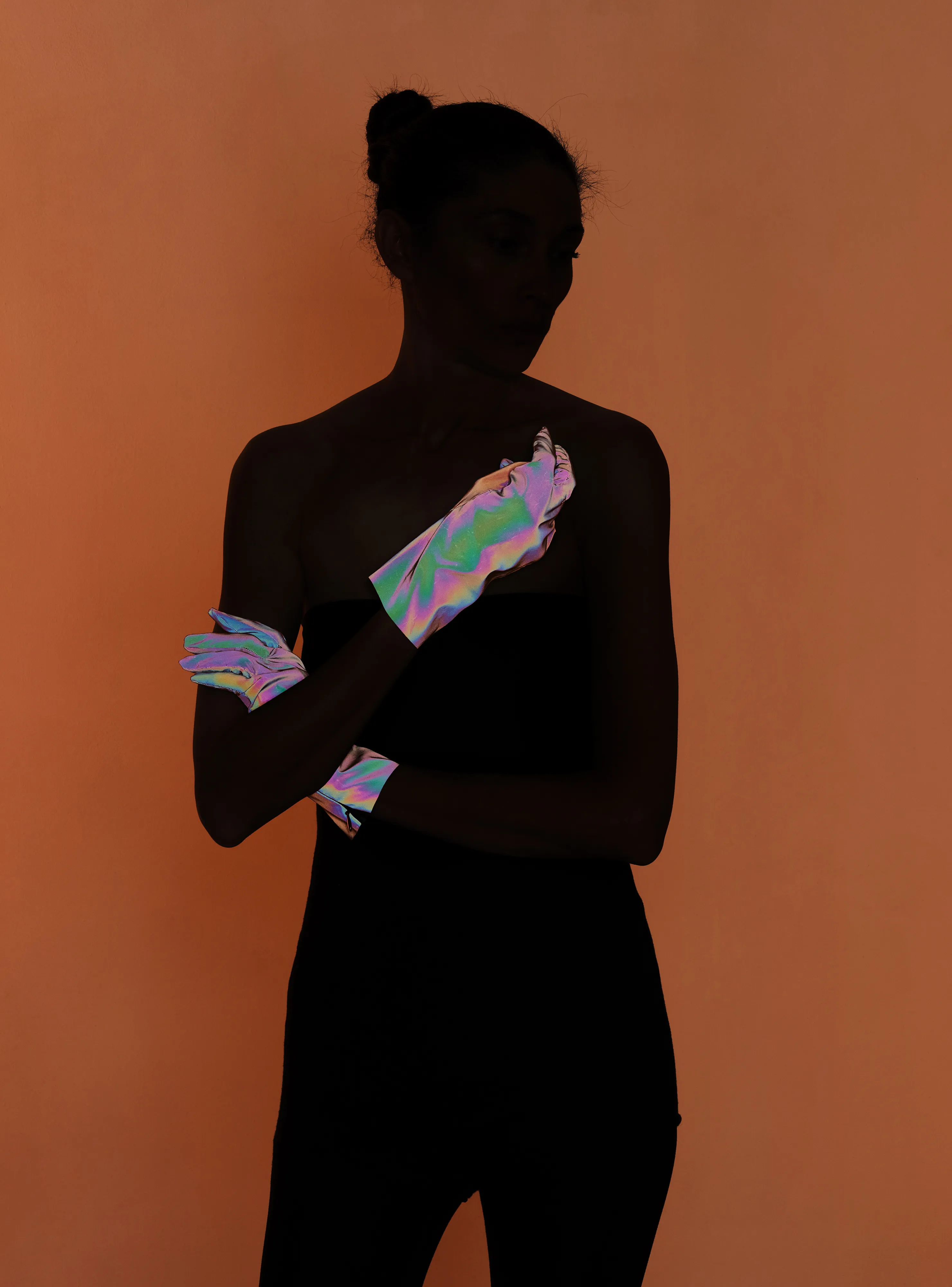 Ursula 3 #32 by Hannah Whitaker

This collection of photographs expands on a character who has been the focal point of my work for a few years: Ursula. I leave ambiguous exactly who and what she is. Her nature is something between an AI, a fictional character, an avatar, a product of the collective imagination, and a living, fully dimensional, being. 

I have previously made two bodies of work with her. The first I published with Image Text Ithaca Press in a book called Ursula. These photographs also comprise my genesis NFT drop. The second I showed recently at Galerie Christophe Gaillard in Paris in an exhibition called Shadow Detail. This third body of work is the first made specifically for the NFT space. I’m calling it Ursula 3, as the third iteration of the project, and in a nod to Web3.

These photographs incorporate some of the photographic techniques that I have used in the past in cultivating the mystique of Ursula—silhouettes, special effect lighting, and printed backgrounds. For Ursula 3 I combined these techniques with a more hands-on approach to set building. I had several props and set materials fabricated out of mirrored plexi, including patterned screens, Ursula’s profile, and her hands. I also had made a turtleneck, gloves, and hoods in reflective materials. In addition to using these props, I incorporated rear projection, a technique used in a pre-digital era of Hollywood filmmaking. 

The sets are more complex than I had done previously, with the intent of making the space in the photographs stranger, more layered, and more difficult to decipher. The resulting photographs evoke the established language of the Ursula lineage but usher her into an increasingly synthetic universe.

Edition: 1 of 1

Commissioned by Obscura
