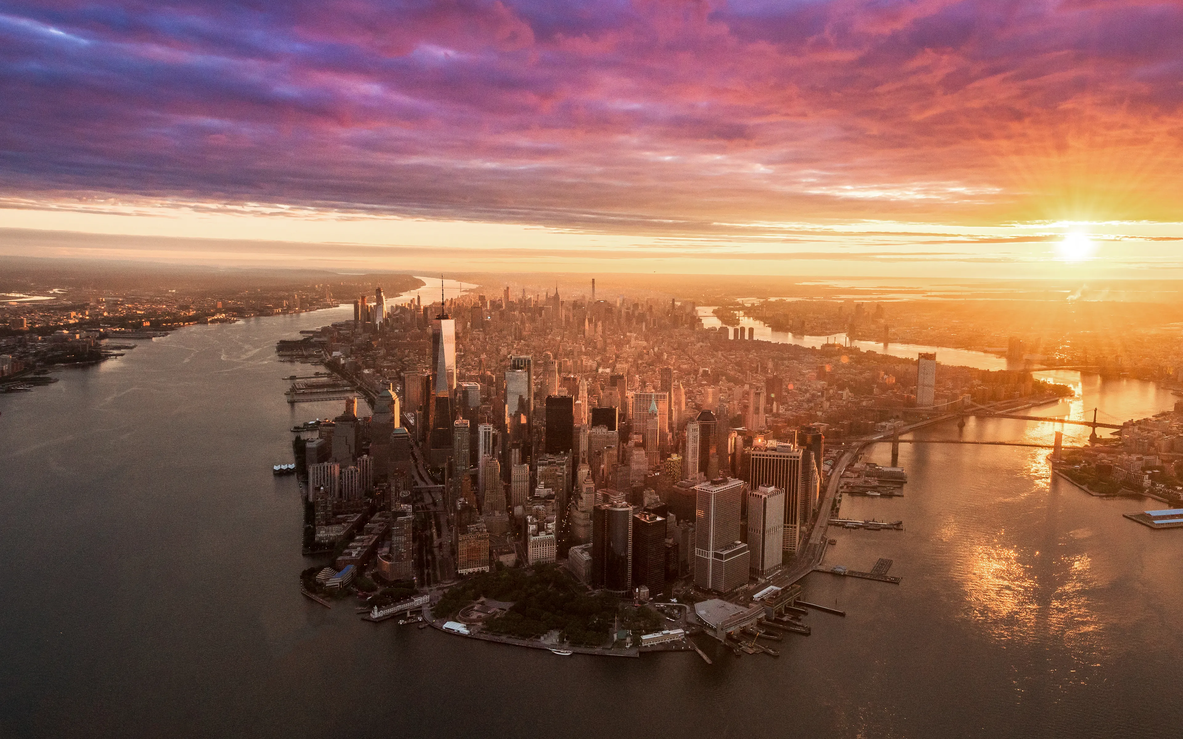 The shot that every aerial photographer wants. Hovering south of The Battery, you try to line the city up in your viewfinder, compose the shot,  and take a second to appreciate the moment that you are about to capture. In that split second, you are greeted by the most epic and delicate light painting the city, the clouds glow like intricate irises , and the rivers shimmer on the precipice. Yeah, it's the Money Shot. 