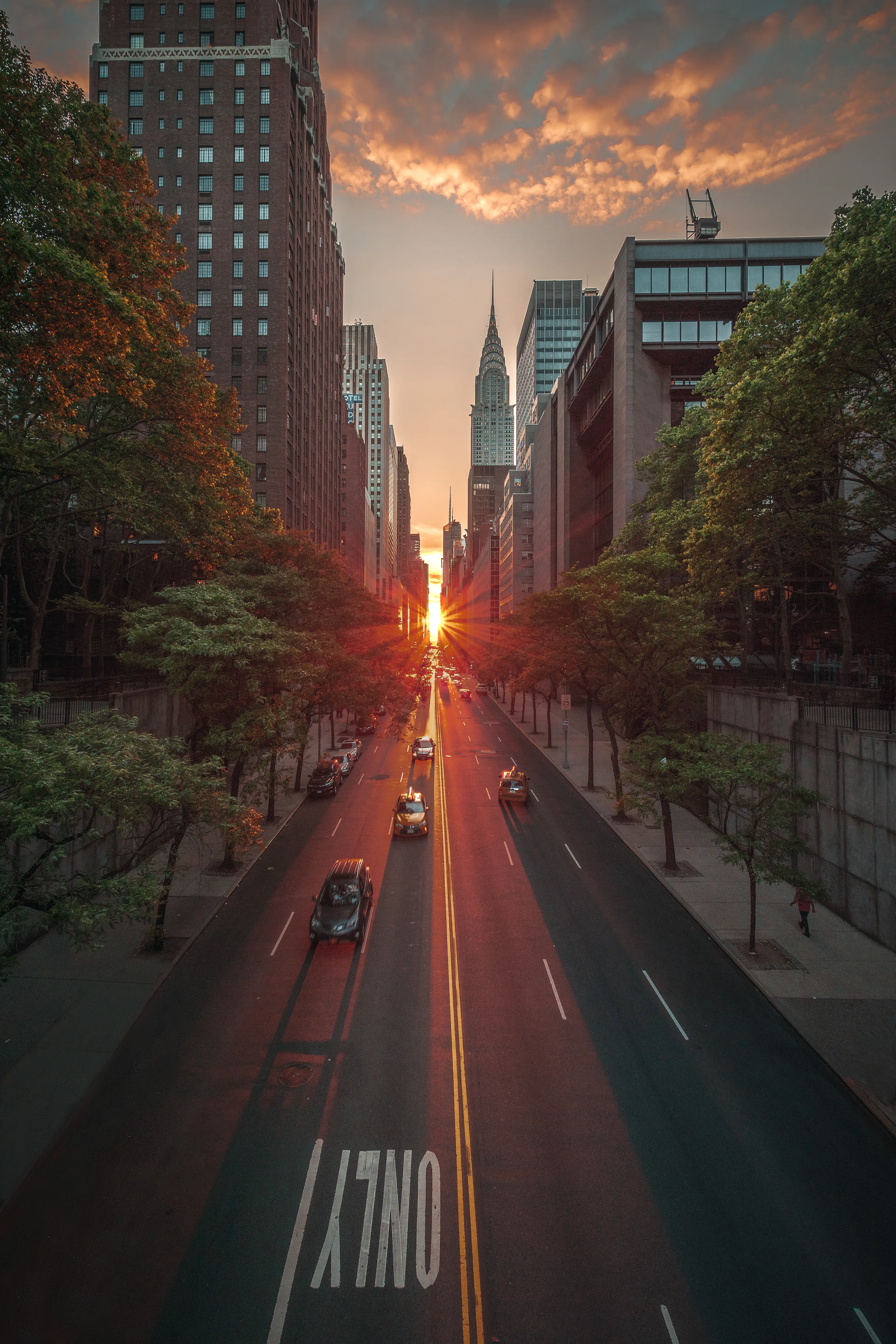 On a select few days every year, the sun aligns perfectly on the street grid in Manhattan. This alignment provides us with this spectacular phenomenon known as Manhattanhenge. On these special days, traffic stops, people crowd the streets, and photographers swarm to their favorite spots. It's as if the city that never sleeps stops dead in its tracks to admire one of Mother Nature's finest displays. It lasts mere moments, but to the viewers, it's a moment they will never forget.