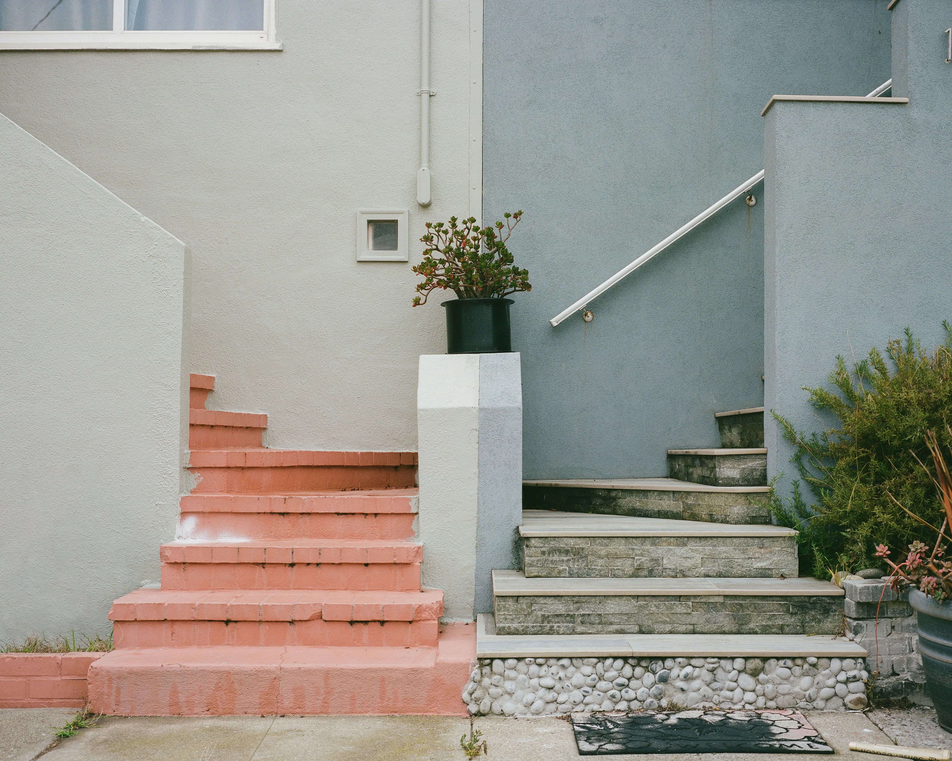 "Come Together" is a limited series, showcasing the Outer Sunset in San Francisco, CA. This iconic neighborhood is full of homes painted in a wide range of colors. Every home has its own distinct identity, created through: decoration, textures, colors, and other personal touches.

While exploring the neighborhood, I came across a handful of homes with unique, back to back front steps. Both homes mirroring one another, offering their own personal touches, coming together to create a cohesive scene; simple, yet full of wonder.