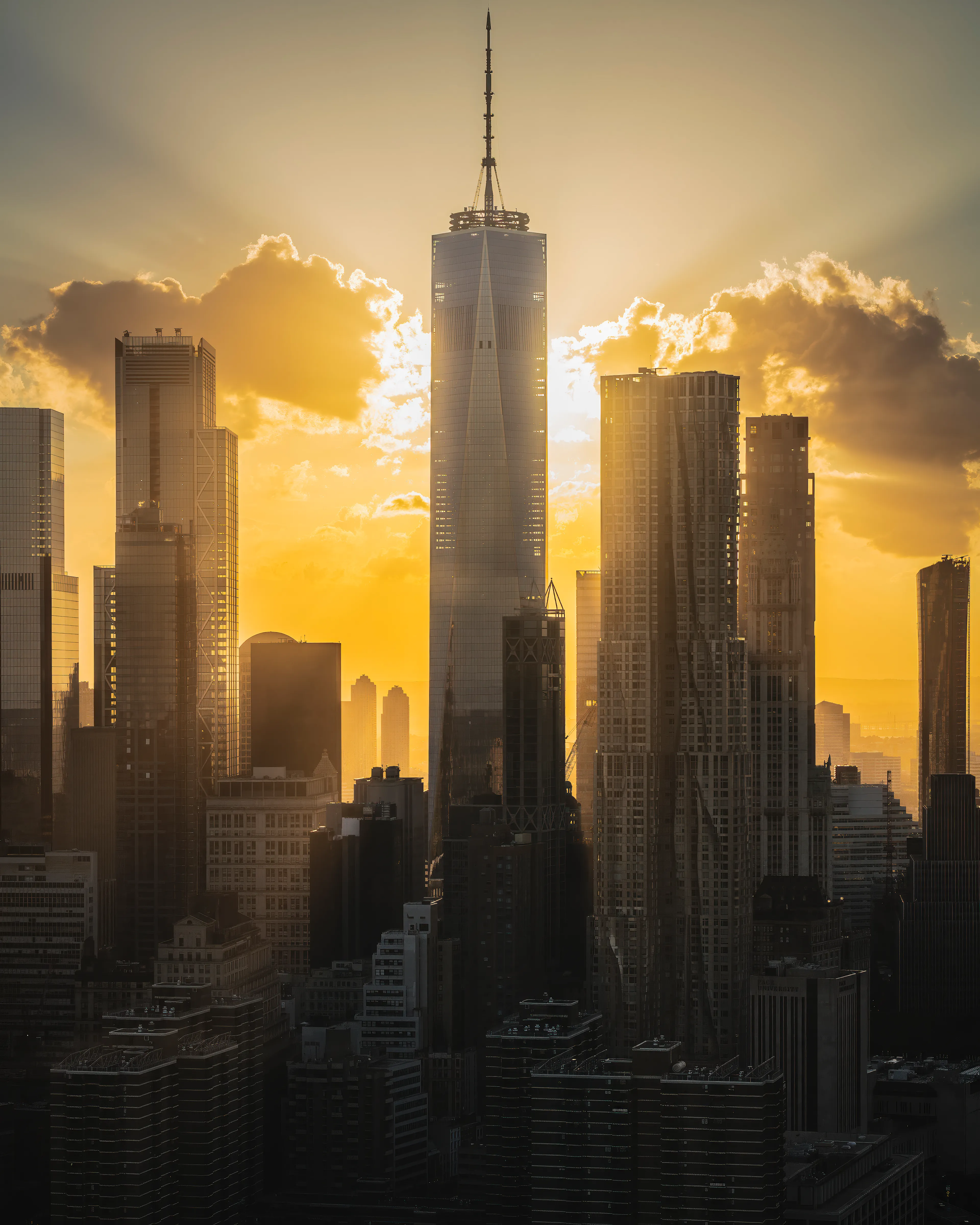 Year IV meant flying a lot more, and bringing my vision and ideas to life. Golden hour in the summer in New York.  Hazy light can provide atmosphere and depth. In the right conditions when the light source is obscured by buildings you can witness momentary magic.  This moment happened so quickly, i actually shot this across the helicopter and the pilot.  One World Trade was being backlit by the sun, and symmetrically framed by clouds and the rest of the downtown denizens.  This split second moment wouldn't have been captured had I not spent hours honing my craft.