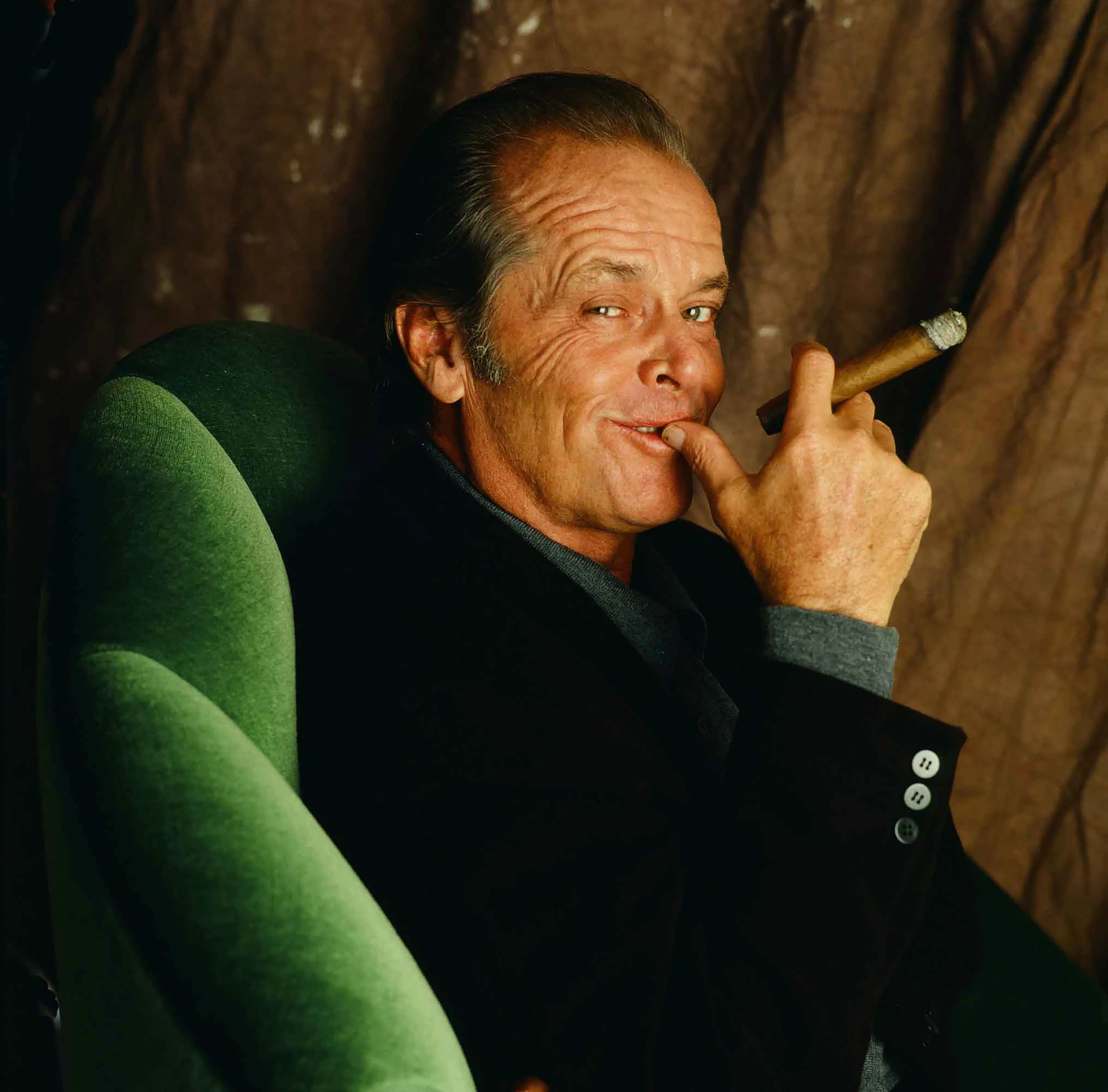Jack Nicholson, 1995 for Cigar Aficionado at his mountain home overlooking Beverly Hills.

In first meeting Nicholson, you wonder who he actually is: boozy Southern lawyer? Short tempered former concert pianist? Sexual jock? Cynical private eye? Con-artist mental patient? Mafia hit man? Philandering journalist? Cigar chomping Marine commander? Out of shape Astronaut? The Joker? The editor-turned-werewolf? The vengeance-driven father?

One thing is obvious, Jack commands the room with his storytelling and his ability to speak intelligently on almost any subject–ancient history, art, politics, women, sports, food, publishing, basketball, movies, Chinese philosophy and how cigars are made. Mixed in with his magnificence art and book collections, are two gleaming Oscar statuettes, and five Golden Globe trophies.  

—-----------------
Collector Bonuses:

The winning collector of this 1-of-1 auctioned NFT will be eligible to receive a signed and dated museum-quality archival print that’s either 28x28 inches or 23x28 inches, depending on the cropping. The print will be shipped in a tube, along with a signed, dated and titled Certificate of Authenticity. 

The winning collector will also be eligible to receive a special bonus NFT from the artist that will be airdropped within 96 hours or more after winning this piece. 

*For shipment of the physical print, please allow 6-8 weeks for delivery.
