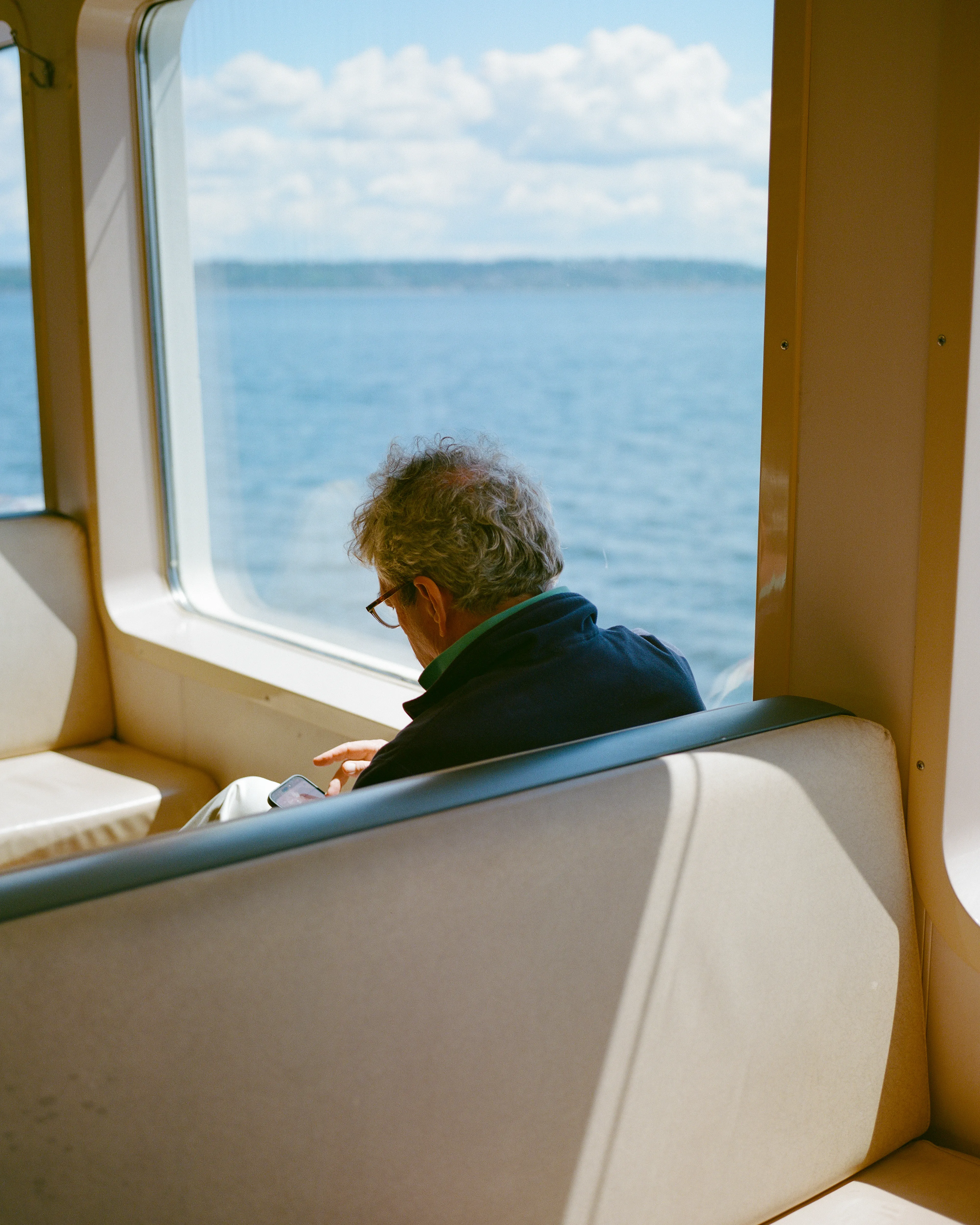 Between shores, a passenger gets lost in his own digital world.