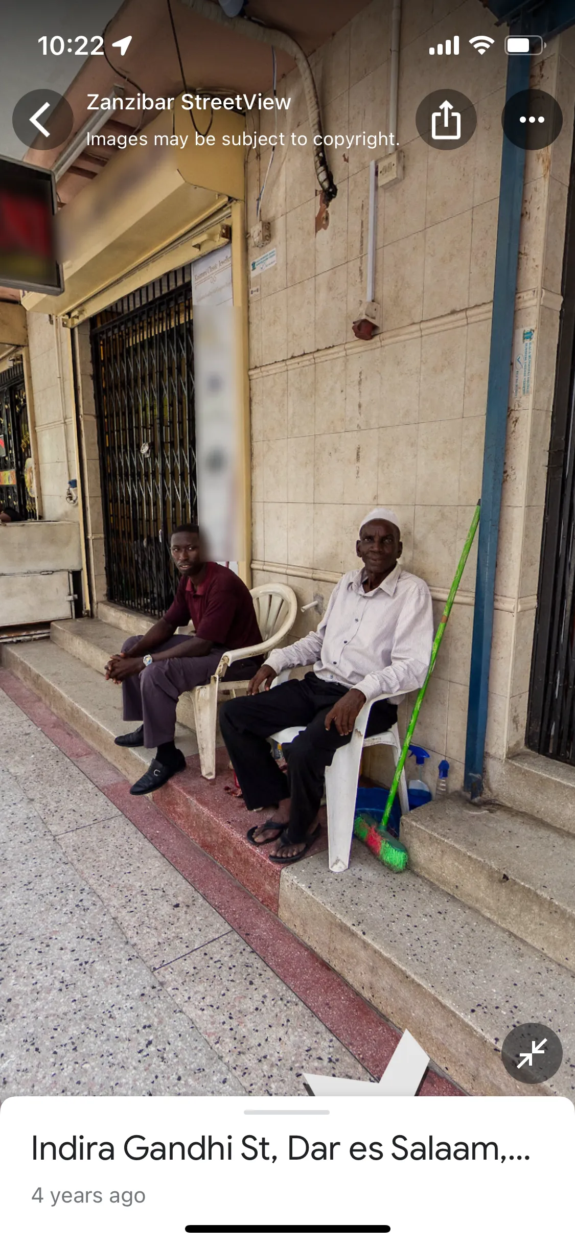 zanzibar.

man in red short sleeve, with tapered pants and buckled shoes.
man in cream button down, black pants and sandals, with traditional headwear.  
smiling, perhaps. 

indira gandhi st, der es salaam.  

about 4 years ago

screenshotted about two days ago.  