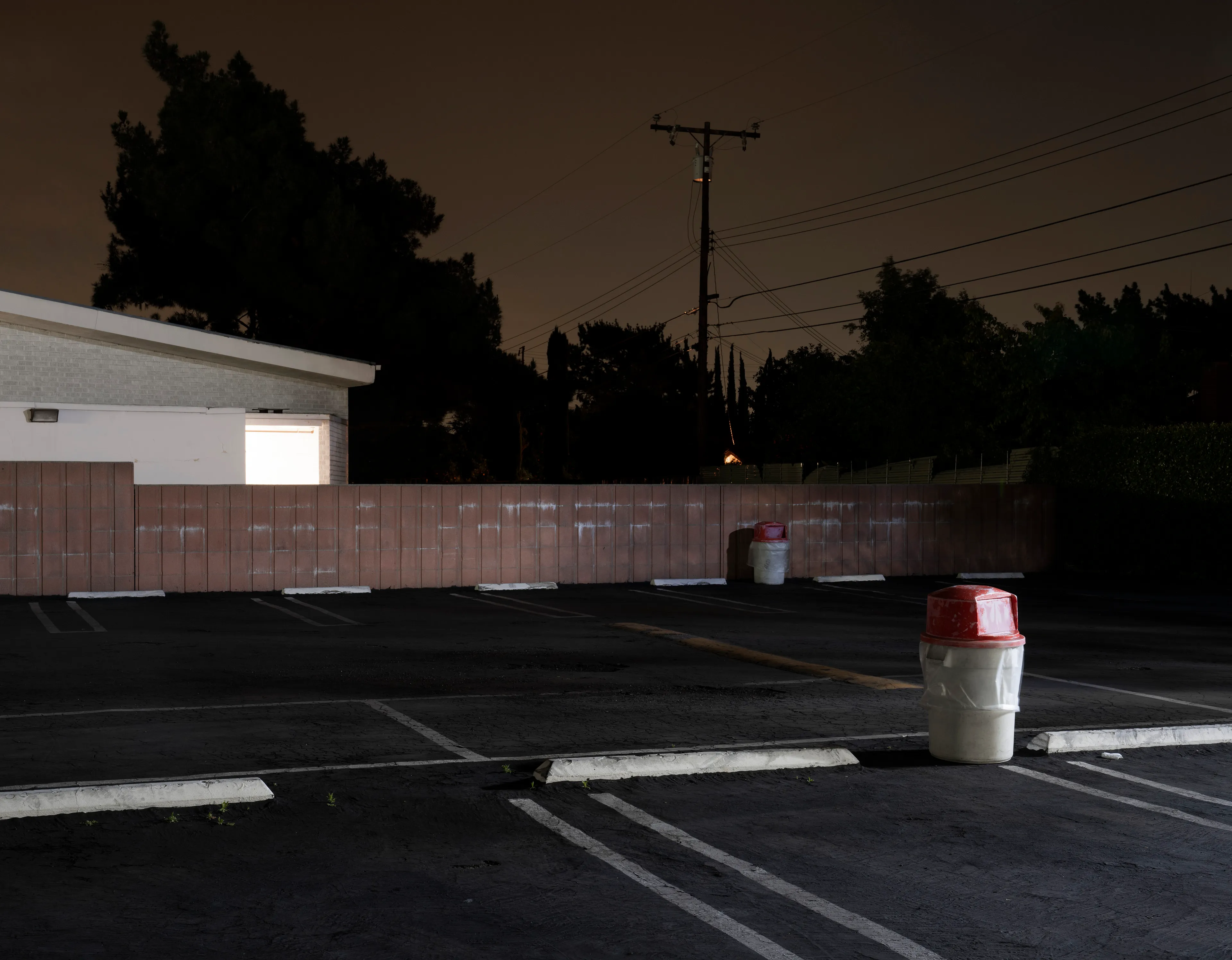 Echoing The World Today's homage to the Mid-20th Century, this collection draws inspiration from "The Pedestrian," a story by Ray Bradbury about a man who wanders city streets alone at night.

Photographing in a different Los Angeles neighborhood each night, people were often skeptical of my presence, drawing a parallel to experiences Bradbury had during his own nocturnal walks in Beverly Hills, which inspired him to write his story seventy-plus years ago.

One night, I decided to bring along Galaxy, my fawn-colored pug, and my presence became more innocuous. He unknowingly became instrumental in finding that unique quietness found only in L.A.'s lonely, dark corners.