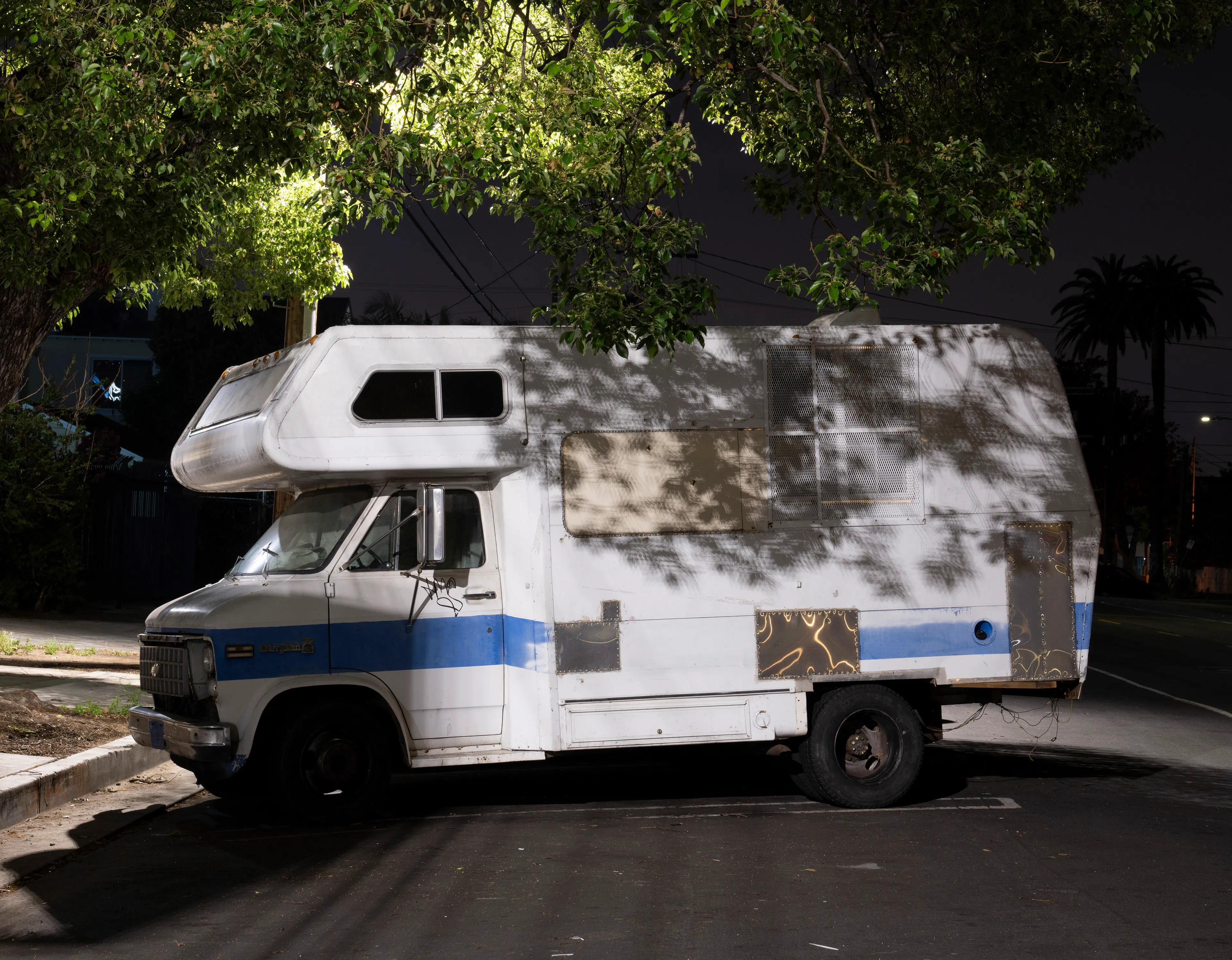 Echoing The World Today's homage to the Mid-20th Century, this collection draws inspiration from "The Pedestrian," a story by Ray Bradbury about a man who wanders city streets alone at night.

Photographing in a different Los Angeles neighborhood each night, people were often skeptical of my presence, drawing a parallel to experiences Bradbury had during his own nocturnal walks in Beverly Hills, which inspired him to write his story seventy-plus years ago.

One night, I decided to bring along Galaxy, my fawn-colored pug, and my presence became more innocuous. He unknowingly became instrumental in finding that unique quietness found only in L.A.'s lonely, dark corners.