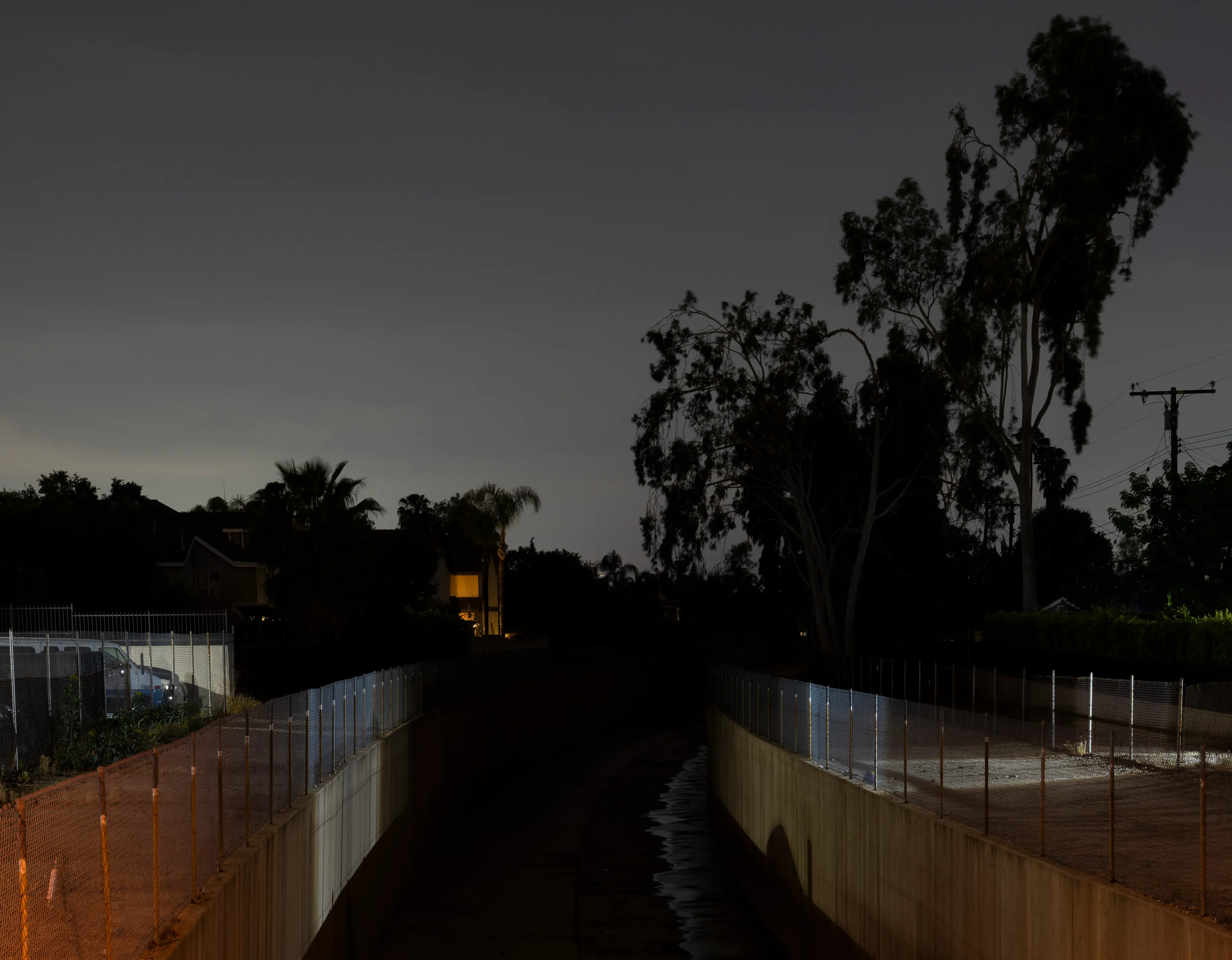 Echoing The World Today's homage to the Mid-20th Century, this collection draws inspiration from "The Pedestrian," a story by Ray Bradbury about a man who wanders city streets alone at night.

Photographing in a different Los Angeles neighborhood each night, people were often skeptical of my presence, drawing a parallel to experiences Bradbury had during his own nocturnal walks in Beverly Hills, which inspired him to write his story seventy-plus years ago.

One night, I decided to bring along Galaxy, my fawn-colored pug, and my presence became more innocuous. He unknowingly became instrumental in finding that unique quietness found only in L.A.'s lonely, dark corners.