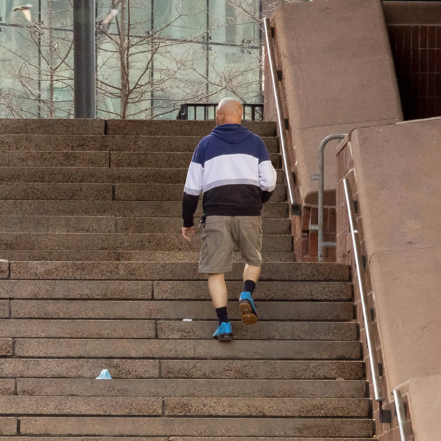 About an Hour: Down and Up (Government Center Steps, Boston, 3,120 exposures from 3:11 to 4:13 pm, March 20, 2022)

About an Hour is a series of photographs of a large staircase at Government Center, Boston. The project consists of two composite photos and 123 pendants derived from the main photo.  One main photo shows only people going down the stairs and facing the camera. The other main photo shows only people going up the stairs with their backs to the camera. The pendants show each figure in isolation, and they are named by the moment I tripped the shutter. The main composites make a generalization. The pendants show the particular.

Each figure in the photos remains in its real, original place. I change nothing. I simply decide what to keep in and what to leave out. The result is both a true record of an hour and an interpretation of it. The camera simply records what’s in front of it, and the moments couldn’t be more ordinary. But to my way of thinking, no one moment is ever typical or repeatable. Each moment holds a mystery, some poetry, some comedy--and lots of tragedy because it is gone as soon as it arrives. The camera can’t arrest the tragedy, of course, but it preserves the mystery.
