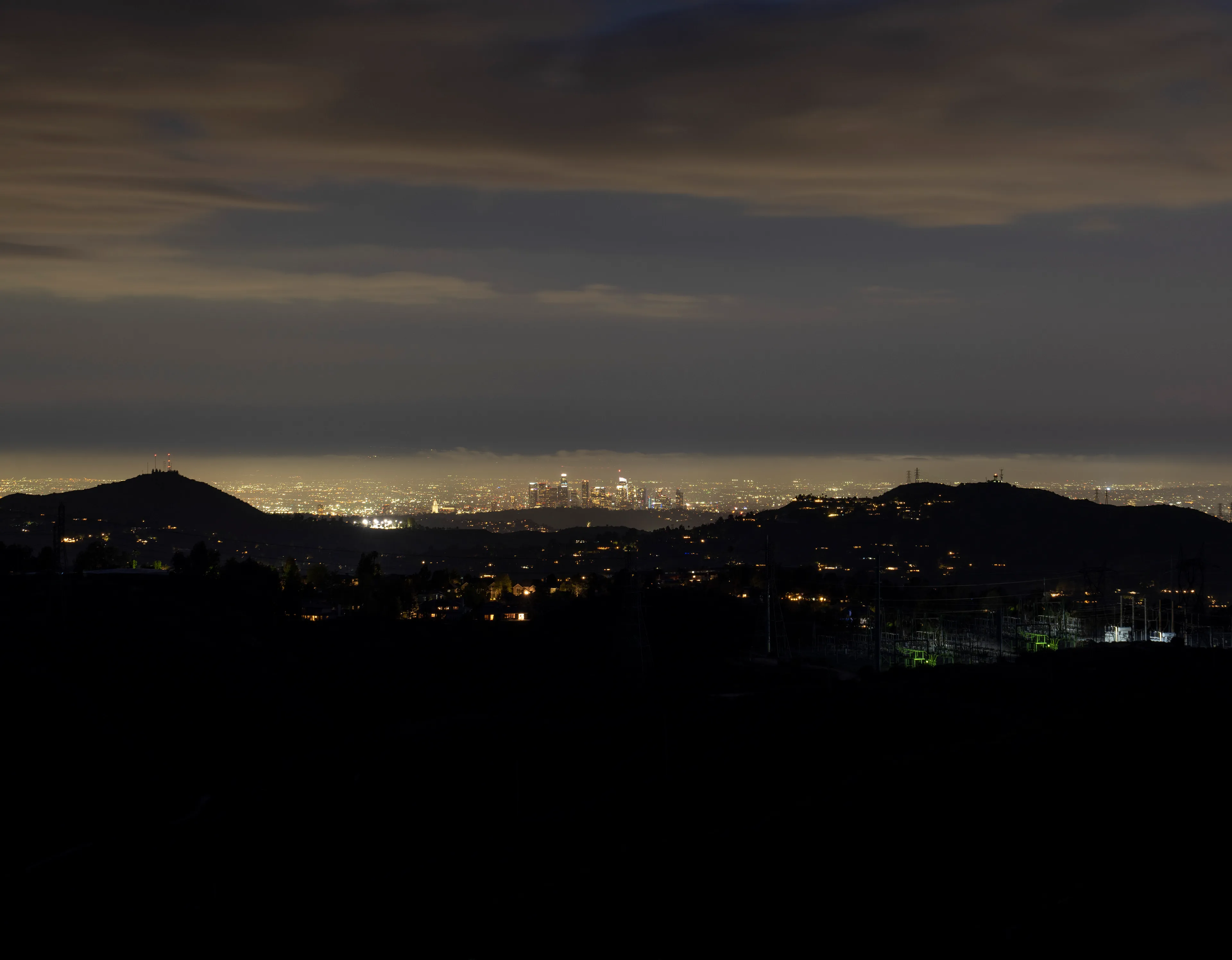 Echoing The World Today's homage to the Mid-20th Century, this collection draws inspiration from "The Pedestrian," a story by Ray Bradbury about a man who wanders city streets alone at night.

Photographing in a different Los Angeles neighborhood each night, people were often skeptical of my presence, drawing a parallel to experiences Bradbury had during his own nocturnal walks in Beverly Hills, which inspired him to write his story seventy-plus years ago.

One night, I decided to bring along Galaxy, my fawn-colored pug, and my presence became more innocuous. He unknowingly became instrumental in finding that unique quietness found only in L.A.'s lonely, dark corners.