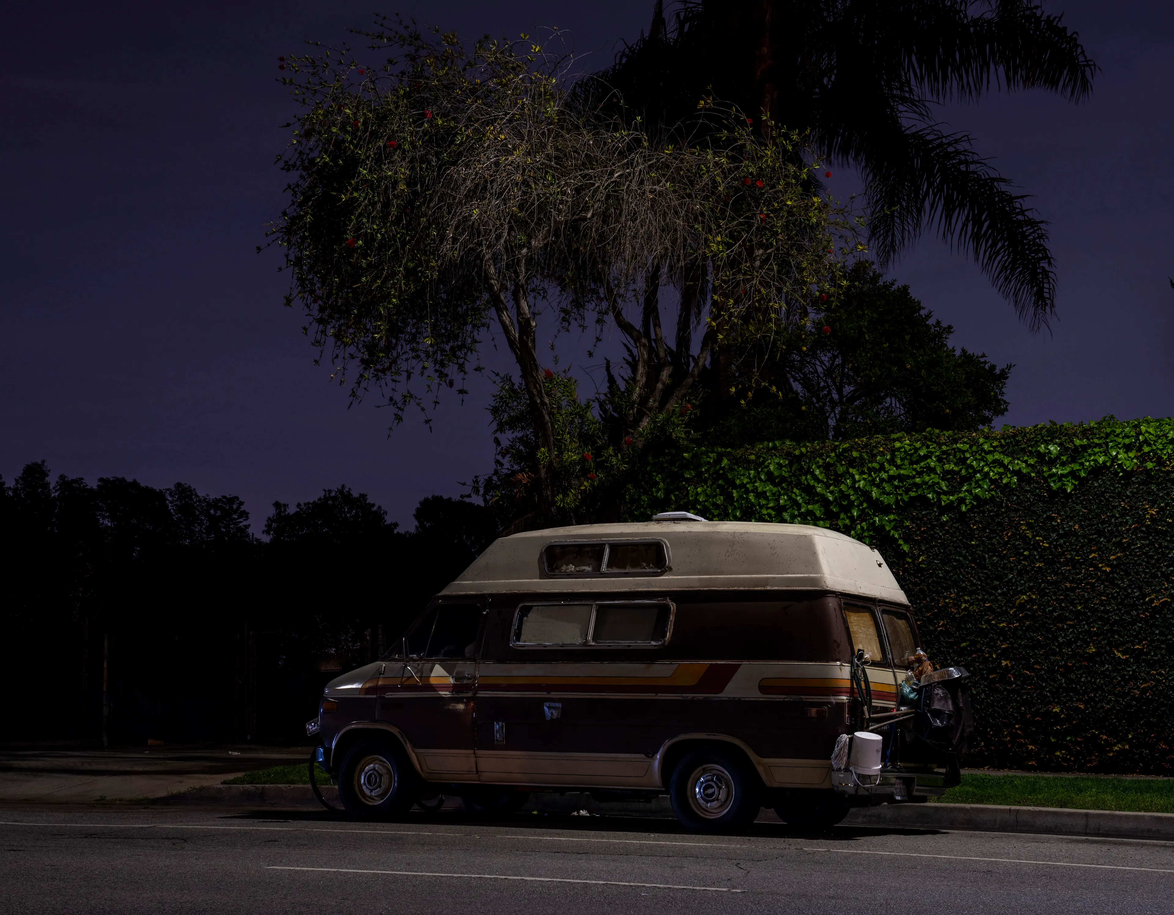 Echoing The World Today's homage to the Mid-20th Century, this collection draws inspiration from "The Pedestrian," a story by Ray Bradbury about a man who wanders city streets alone at night.

Photographing in a different Los Angeles neighborhood each night, people were often skeptical of my presence, drawing a parallel to experiences Bradbury had during his own nocturnal walks in Beverly Hills, which inspired him to write his story seventy-plus years ago.

One night, I decided to bring along Galaxy, my fawn-colored pug, and my presence became more innocuous. He unknowingly became instrumental in finding that unique quietness found only in L.A.'s lonely, dark corners.