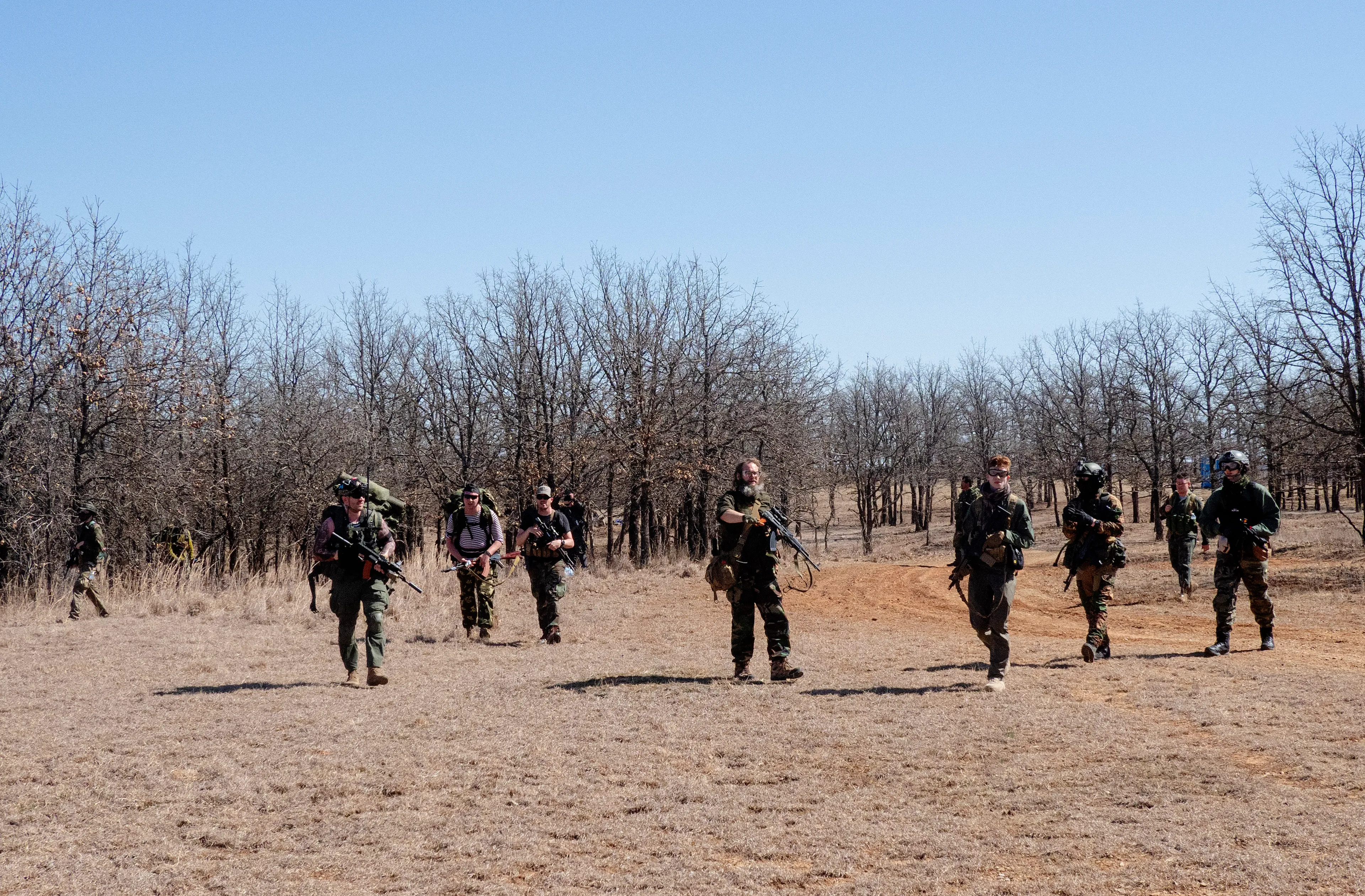 USA. Oklahoma. Overbrook. Battle Springs Ranch. March 2022. Battle between NATO and Russian forces. Killed and injured. Milsim, military simulation, airsoft weekend full immersion event. In a scenario where US and NATO troops, after loosing the battle of Kharkiv are trying to take back the Russian garrison town of Sarsk in the Rostov region close to the Ukrainian border. US FOR versus RUS FOR. Milsim West has been reenacting similar scenarios for a dozen of years and the similarity to current events is coincidental.