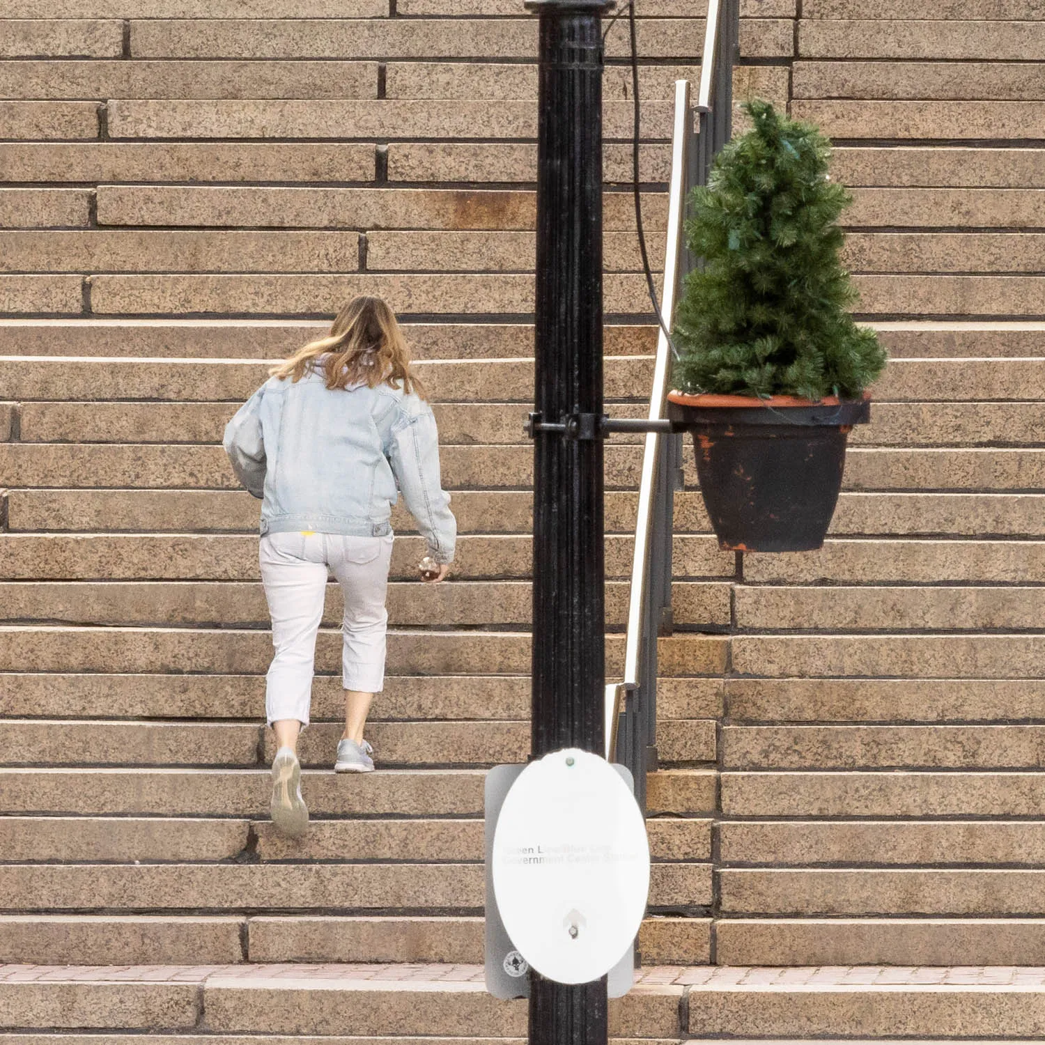 About an Hour: Down and Up (Government Center Steps, Boston, 3,120 exposures from 3:11 to 4:13 pm, March 20, 2022)

About an Hour is a series of photographs of a large staircase at Government Center, Boston. The project consists of two composite photos and 123 pendants derived from the main photo.  One main photo shows only people going down the stairs and facing the camera. The other main photo shows only people going up the stairs with their backs to the camera. The pendants show each figure in isolation, and they are named by the moment I tripped the shutter. The main composites make a generalization. The pendants show the particular.

Each figure in the photos remains in its real, original place. I change nothing. I simply decide what to keep in and what to leave out. The result is both a true record of an hour and an interpretation of it. The camera simply records what’s in front of it, and the moments couldn’t be more ordinary. But to my way of thinking, no one moment is ever typical or repeatable. Each moment holds a mystery, some poetry, some comedy--and lots of tragedy because it is gone as soon as it arrives. The camera can’t arrest the tragedy, of course, but it preserves the mystery.
