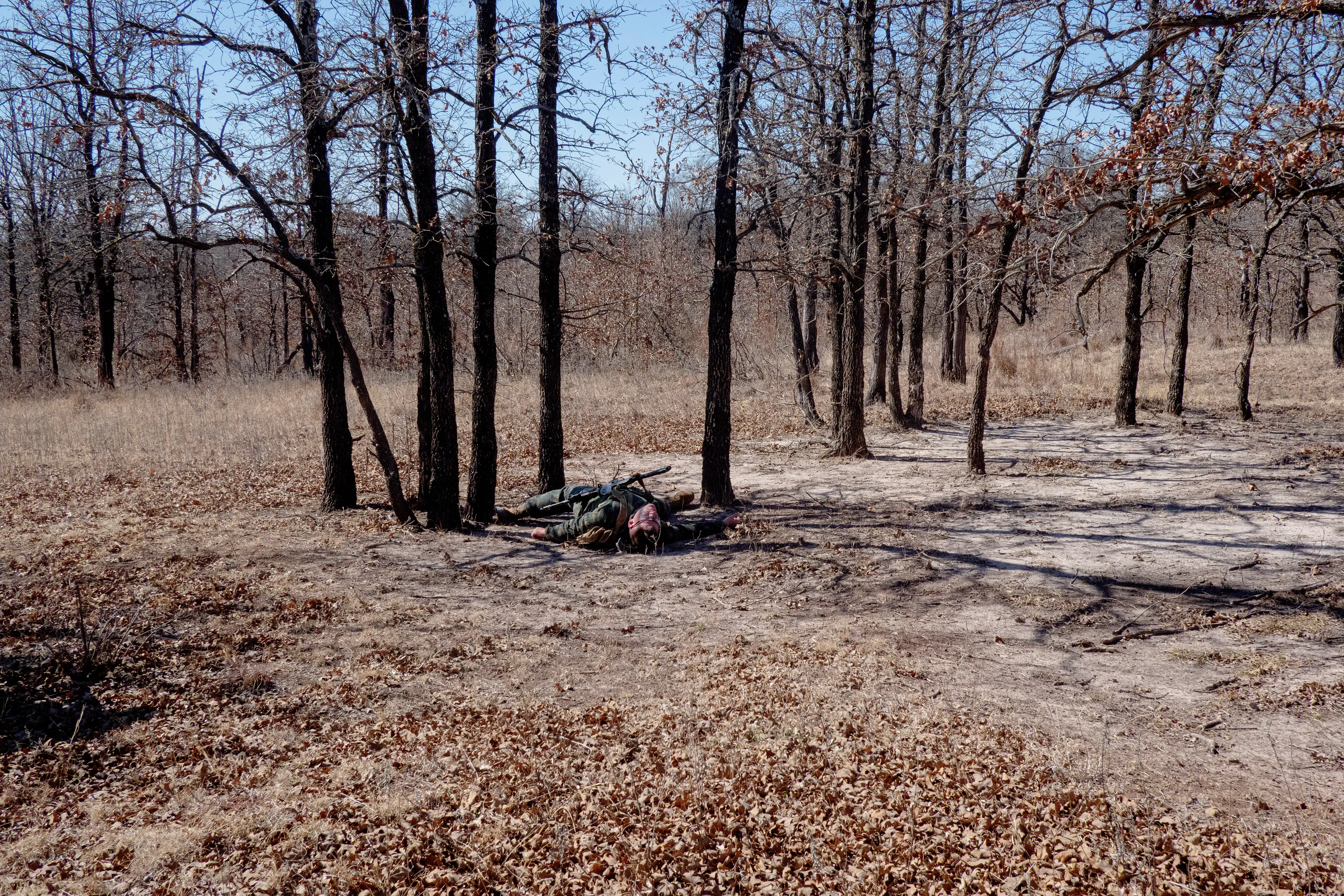 USA. Oklahoma. Overbrook. Battle Springs Ranch. March 2022. Battle between NATO and Russian forces. Killed and injured. Milsim, military simulation, airsoft weekend full immersion event. In a scenario where US and NATO troops, after loosing the battle of Kharkiv are trying to take back the Russian garrison town of Sarsk in the Rostov region close to the Ukrainian border. US FOR versus RUS FOR. Milsim West has been reenacting similar scenarios for a dozen of years and the similarity to current events is coincidental.