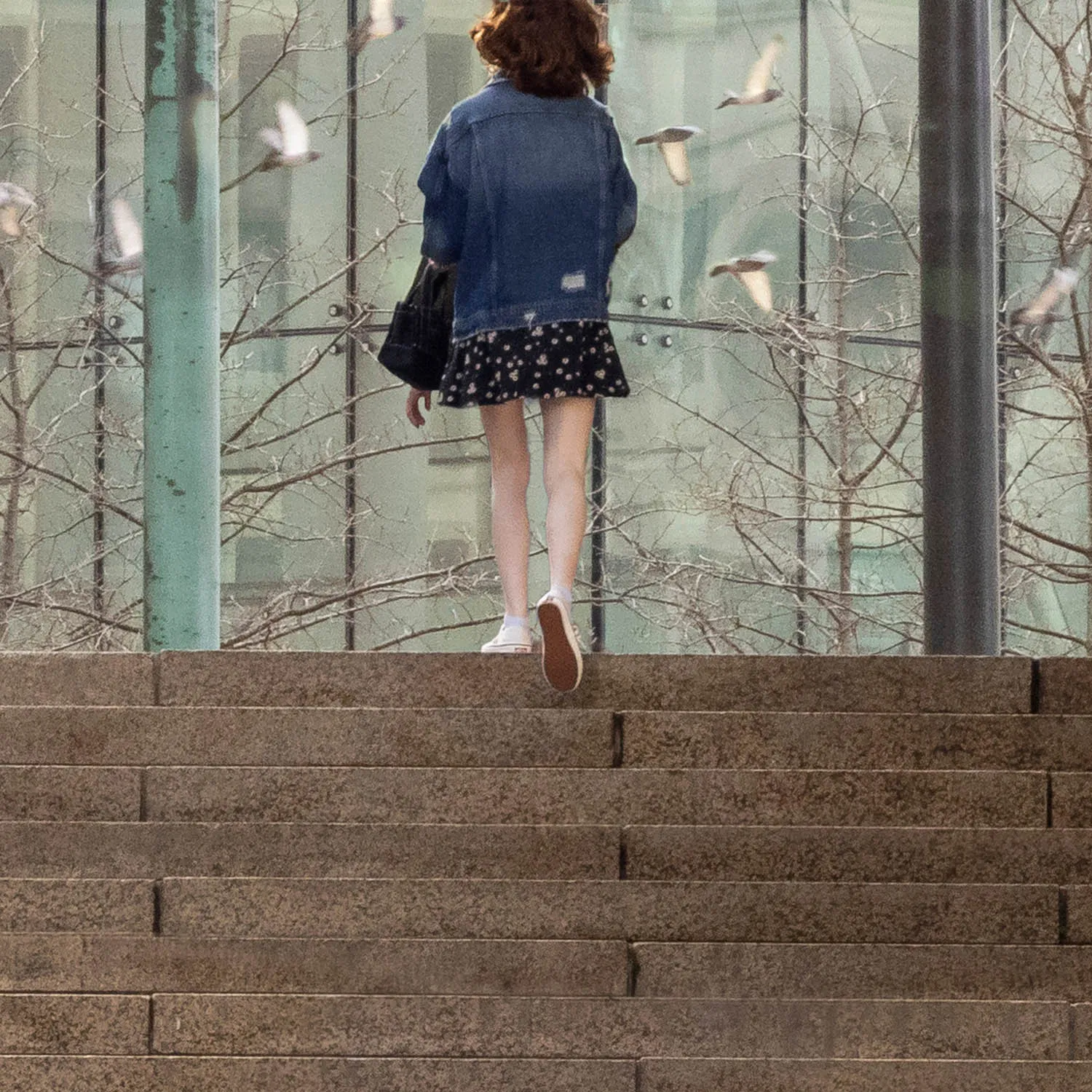 About an Hour: Down and Up (Government Center Steps, Boston, 3,120 exposures from 3:11 to 4:13 pm, March 20, 2022)

About an Hour is a series of photographs of a large staircase at Government Center, Boston. The project consists of two composite photos and 123 pendants derived from the main photo.  One main photo shows only people going down the stairs and facing the camera. The other main photo shows only people going up the stairs with their backs to the camera. The pendants show each figure in isolation, and they are named by the moment I tripped the shutter. The main composites make a generalization. The pendants show the particular.

Each figure in the photos remains in its real, original place. I change nothing. I simply decide what to keep in and what to leave out. The result is both a true record of an hour and an interpretation of it. The camera simply records what’s in front of it, and the moments couldn’t be more ordinary. But to my way of thinking, no one moment is ever typical or repeatable. Each moment holds a mystery, some poetry, some comedy--and lots of tragedy because it is gone as soon as it arrives. The camera can’t arrest the tragedy, of course, but it preserves the mystery.
