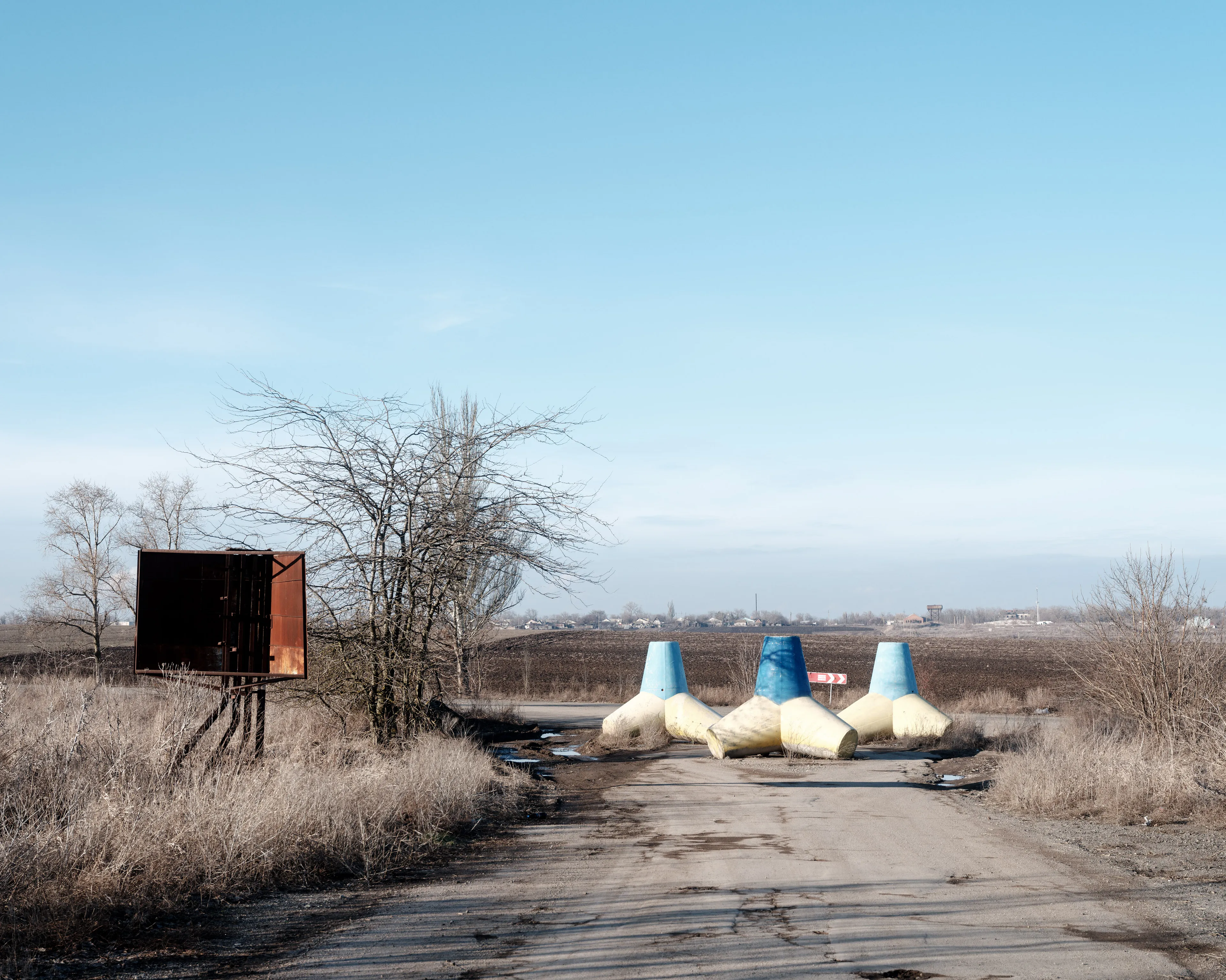 This selection of 100 images represents my trip to Ukraine from the 14th of February 2022 until the 24th of February 2022, the day the Russian army started its invasion. - An abandoned checkpoint