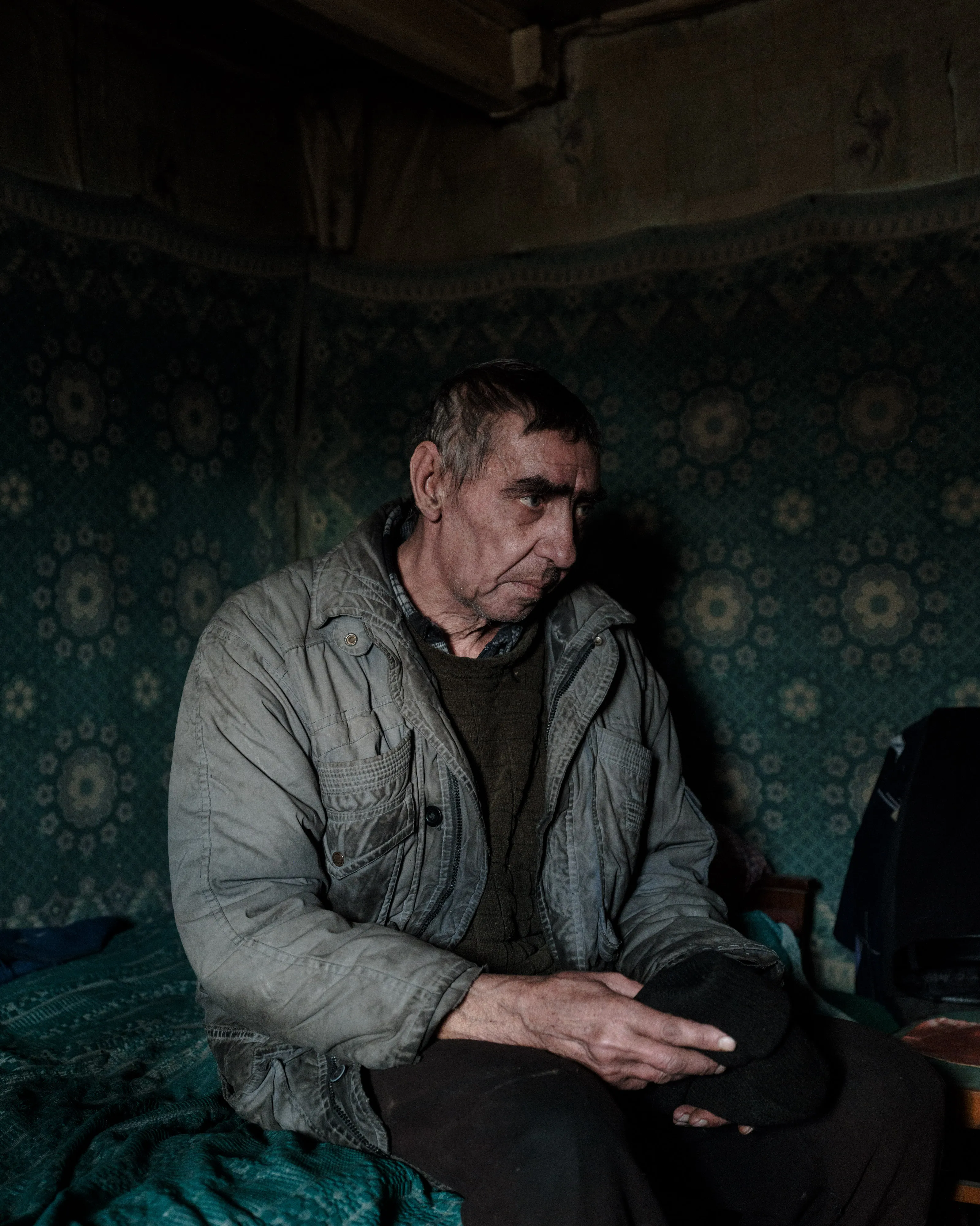 This selection of 100 images represents my trip to Ukraine from the 14th of February 2022 until the 24th of February 2022, the day the Russian army started its invasion. - Nikolaï, 60, a retired man, portraied  in the room where he was when an artillery shell hit the windows of his house.