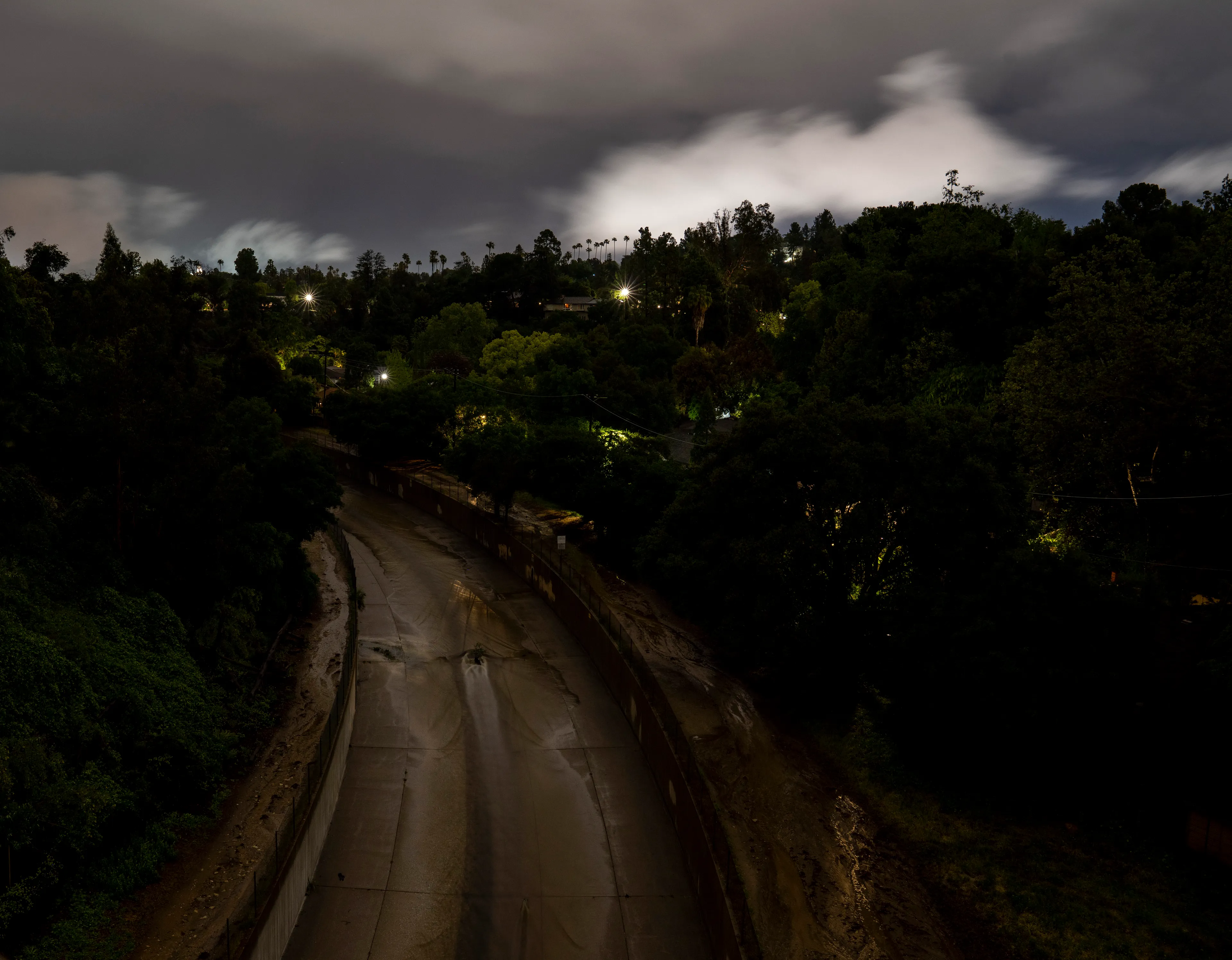 Echoing The World Today's homage to the Mid-20th Century, this collection draws inspiration from "The Pedestrian," a story by Ray Bradbury about a man who wanders city streets alone at night.

Photographing in a different Los Angeles neighborhood each night, people were often skeptical of my presence, drawing a parallel to experiences Bradbury had during his own nocturnal walks in Beverly Hills, which inspired him to write his story seventy-plus years ago.

One night, I decided to bring along Galaxy, my fawn-colored pug, and my presence became more innocuous. He unknowingly became instrumental in finding that unique quietness found only in L.A.'s lonely, dark corners.