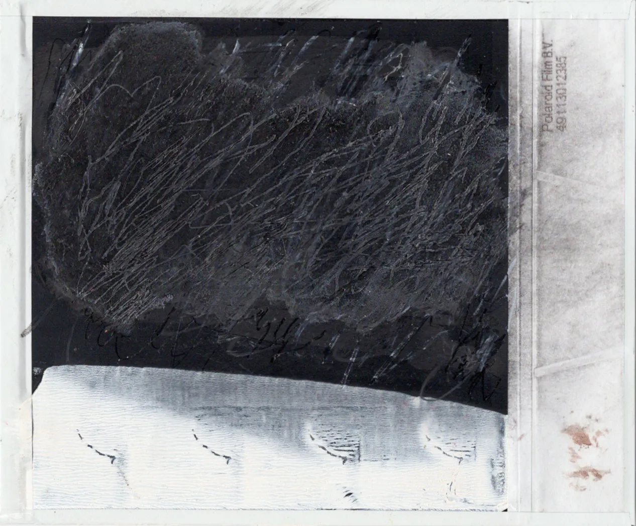 Scratches and glue on polaroid.