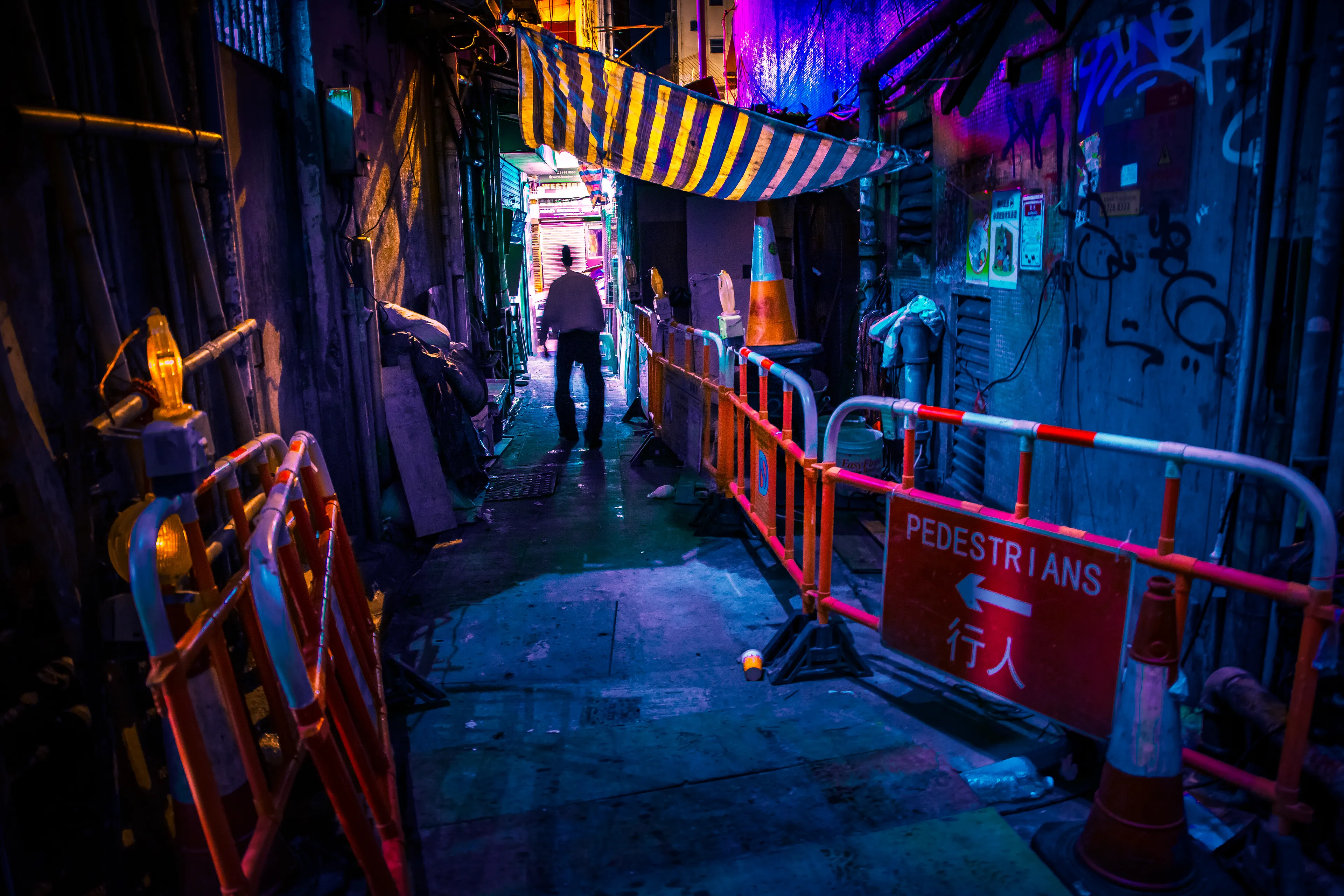 During my trip to Hong Kong, I spent every night out shooting and exploring the streets. I would spend my nights shooting until morning. One of these evenings I was out in an alley when my battery died, so I tried to change my battery but almost dropped my camera on the ground. Just as I changed the battery, this drunk older guy swiveled past me. I didn't have time to change my settings, so he came out a little blurry but I personally think that makes the photo have more character.