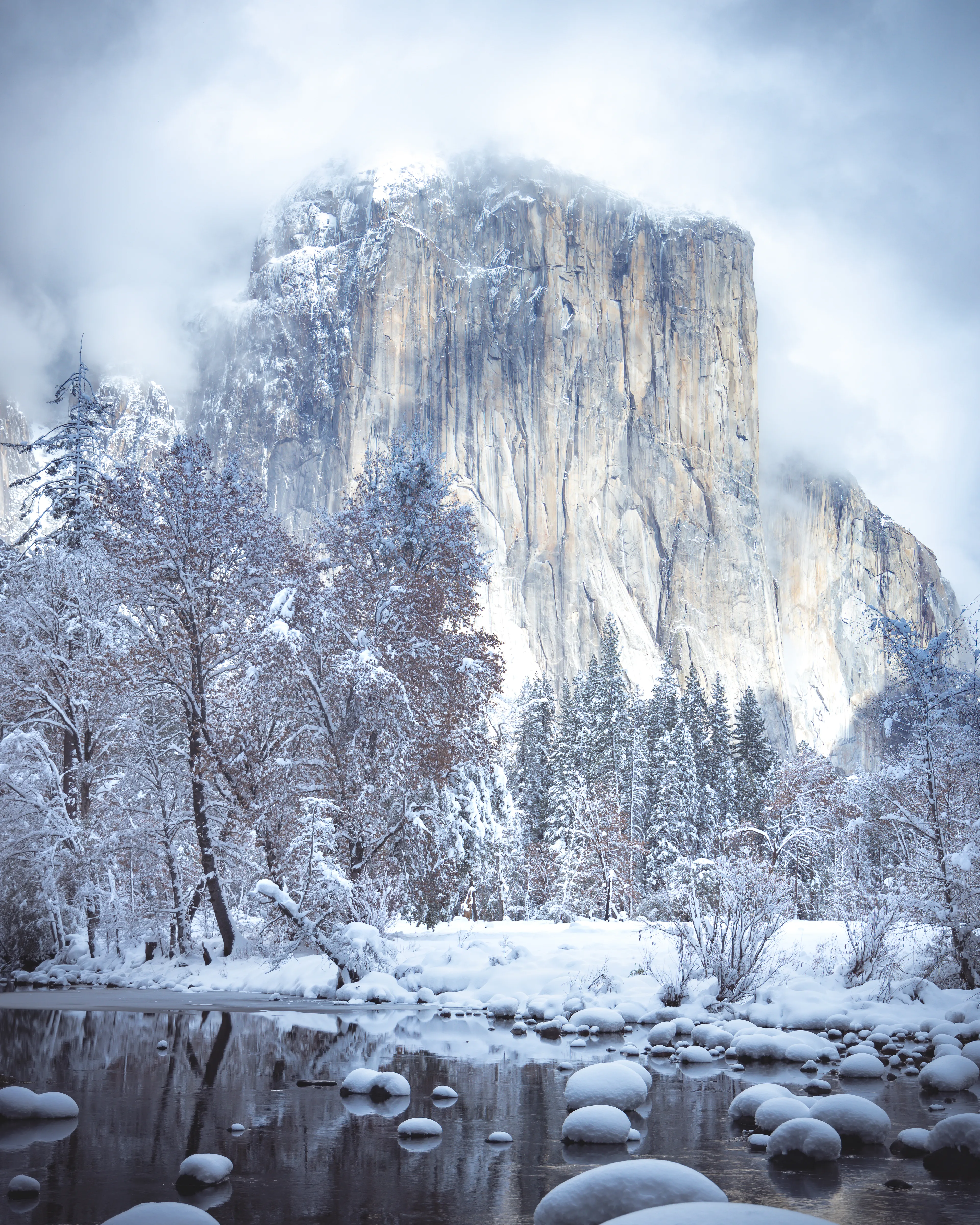 With snow in the forecast, I spontaneously decided to pack up my photo gear, hop in my truck, and cruise out to Yosemite at 2am. The 3 1/2 hour drive from Oakland, CA is always an exciting one, no matter how little sleep I've had. Knowing that Yosemite National Park is waiting at the end of the drive is incentive enough to power through. 

The snow started to fall pretty heavily as I gained some elevation. Before I knew it, the roads were completely covered in snow, so I pulled over to throw chains on the tires. There was virtually nobody else on the road on their way into the park, which was very exciting.

I got into Yosemite, chains on, and the park was absolutely empty. It was a winter wonderland, and felt like I had the entire park all to myself. Throughout the day, the sun started to peak out through the clouds, and I snapped this shot of El Capitan. It's definitely one of my favorites of this iconic rock wall.

**First collector will receive a physical print of their choosing**
