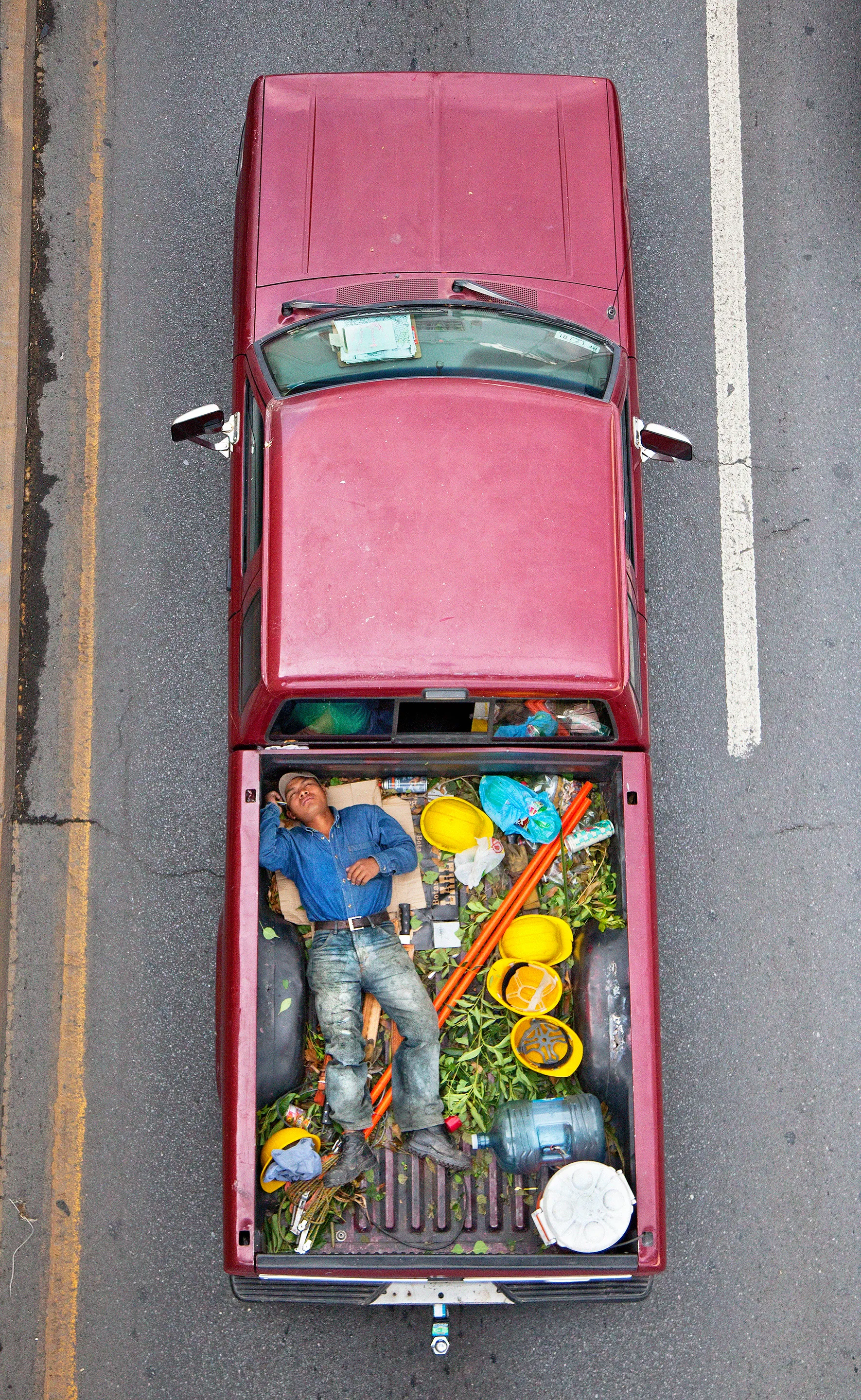 This photograph is part of my series, Carpoolers, which depicts laborers in México captured from an overpass, commuting between distant suburbs and urban centers. Like much of my work, this project comes from a desire to tell the story of the dramatic environmental, economic, and demographic changes playing out in my home city of Monterrey. This series has circulated the internet since 2011 and has been exhibited widely around the world. This piece is part of a collection of 50 works.