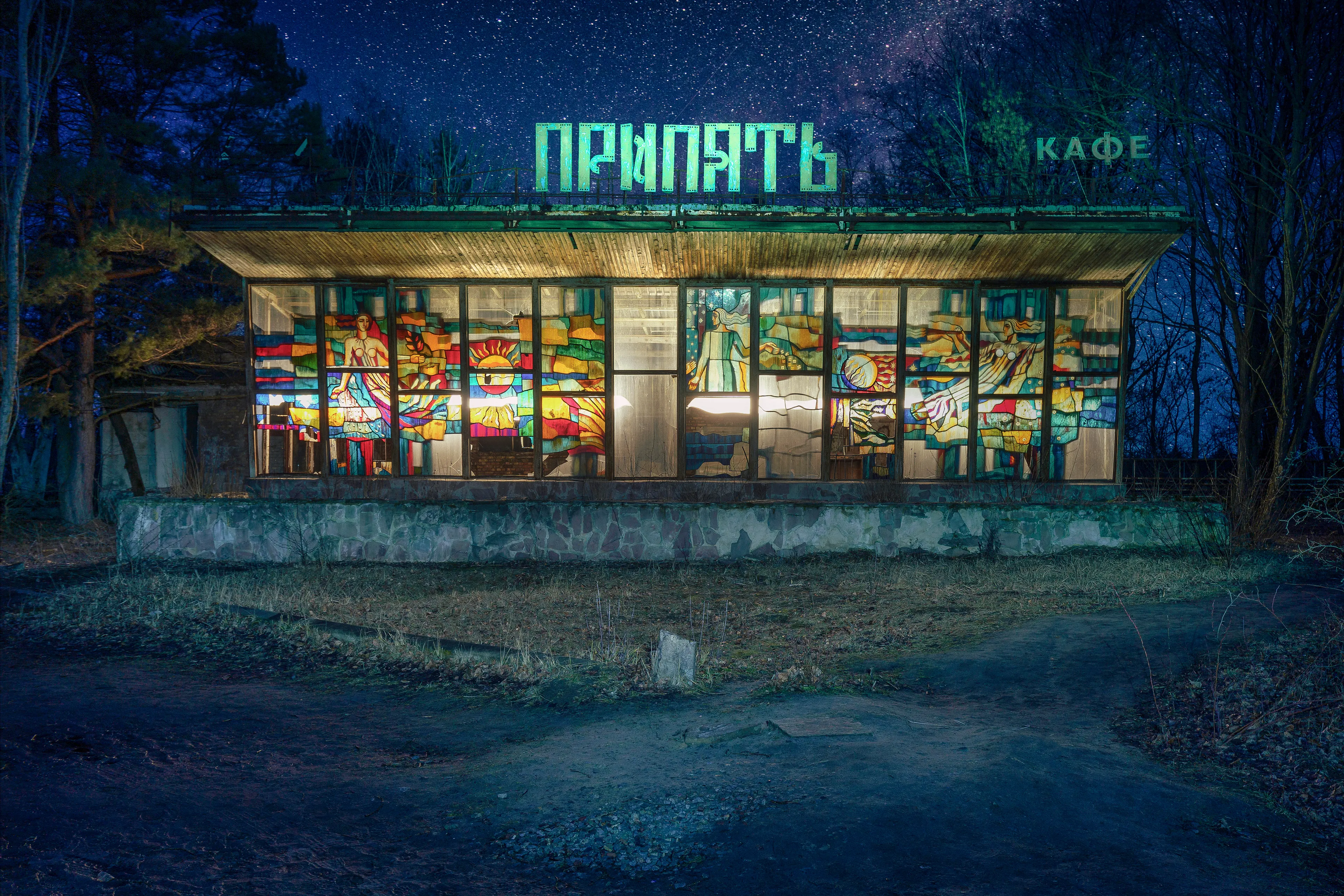 Night has long fallen on the ghost town of Pripyat. In the distance you can hear the wild dogs barking and from the nearby bank of the river of the same name you can hear the croaking of frogs. I am standing in front of the former excursion restaurant "Cafe Pripyat" with its beautiful stained glass windows and detailed Sovjet mural. Back then you got the best ice cream in town here.

During my exposure I realize that I am standing completely alone in a city which was inhabited by almost 50,000 people until April 25, 1986. I am not afraid, I enjoy with humility. For despite all the terrible events that have happened here, it is now an oasis for nature. Impressive how quickly it recovers when we leave it alone.

I realize how much I like being here and how much peace I find here. The exclusion zone is like my second home and I hope to come back soon.

