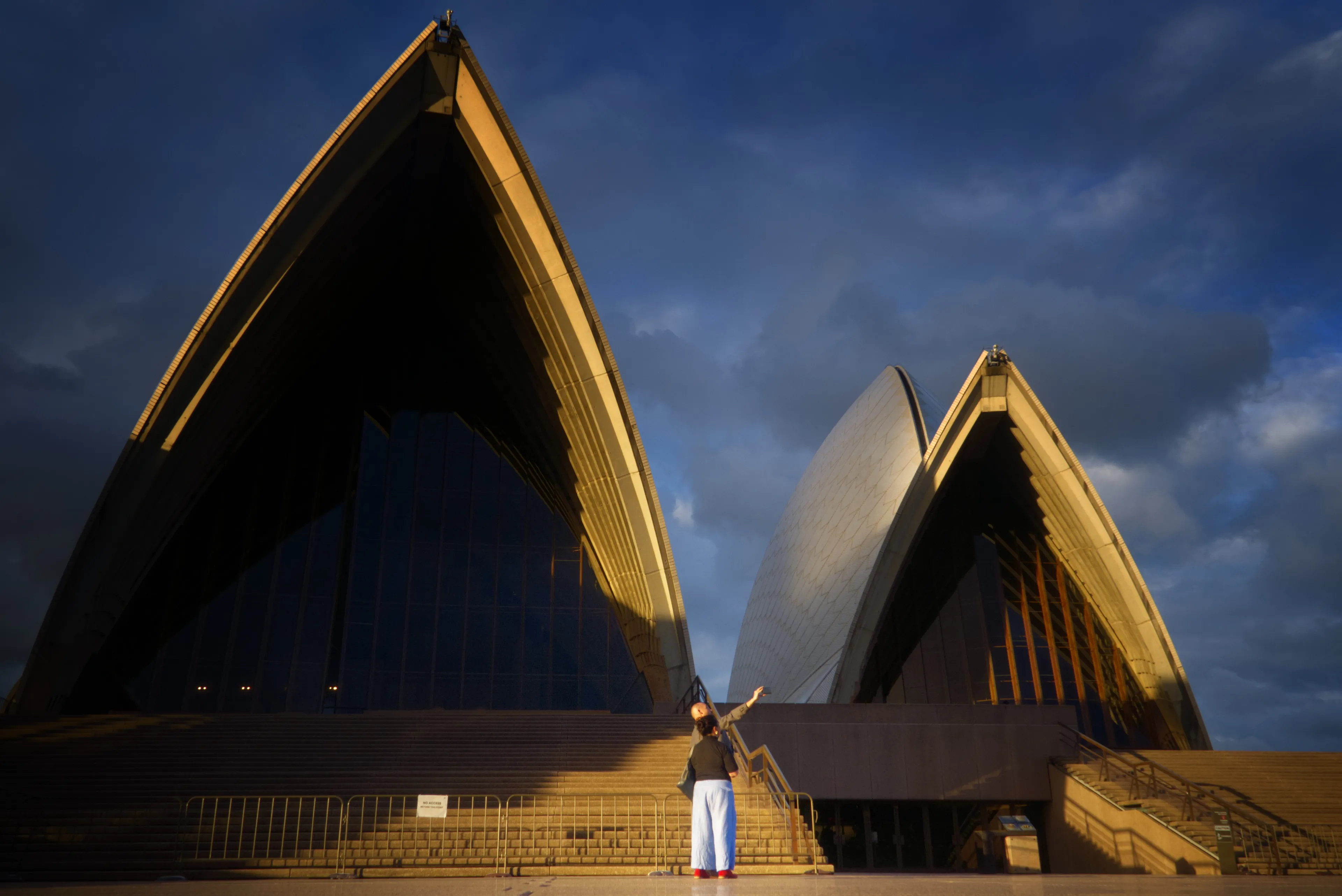 This is part of my Sydney 2021 series.  An unusually quiet Opera House is the backdrop for a metaphor about the transition from Web2 to Web3.

The act of taking a selfie to put on Facebook is a very Web2 experience.  

In Web3 in 2021 we have seen wild creations born of unique visions - much like the Opera House itself.

In this image an unstoppable wave of beauty innovation, history and culture stands poised to break over the legacy world.

This image was made possible by the unique circumstances of 2021, when the COVID-19 pandemic kept international tourists away from Sydney.  The pandemic also drove many people to explore Web3 from their homes, adding an extra dimension to the photo.