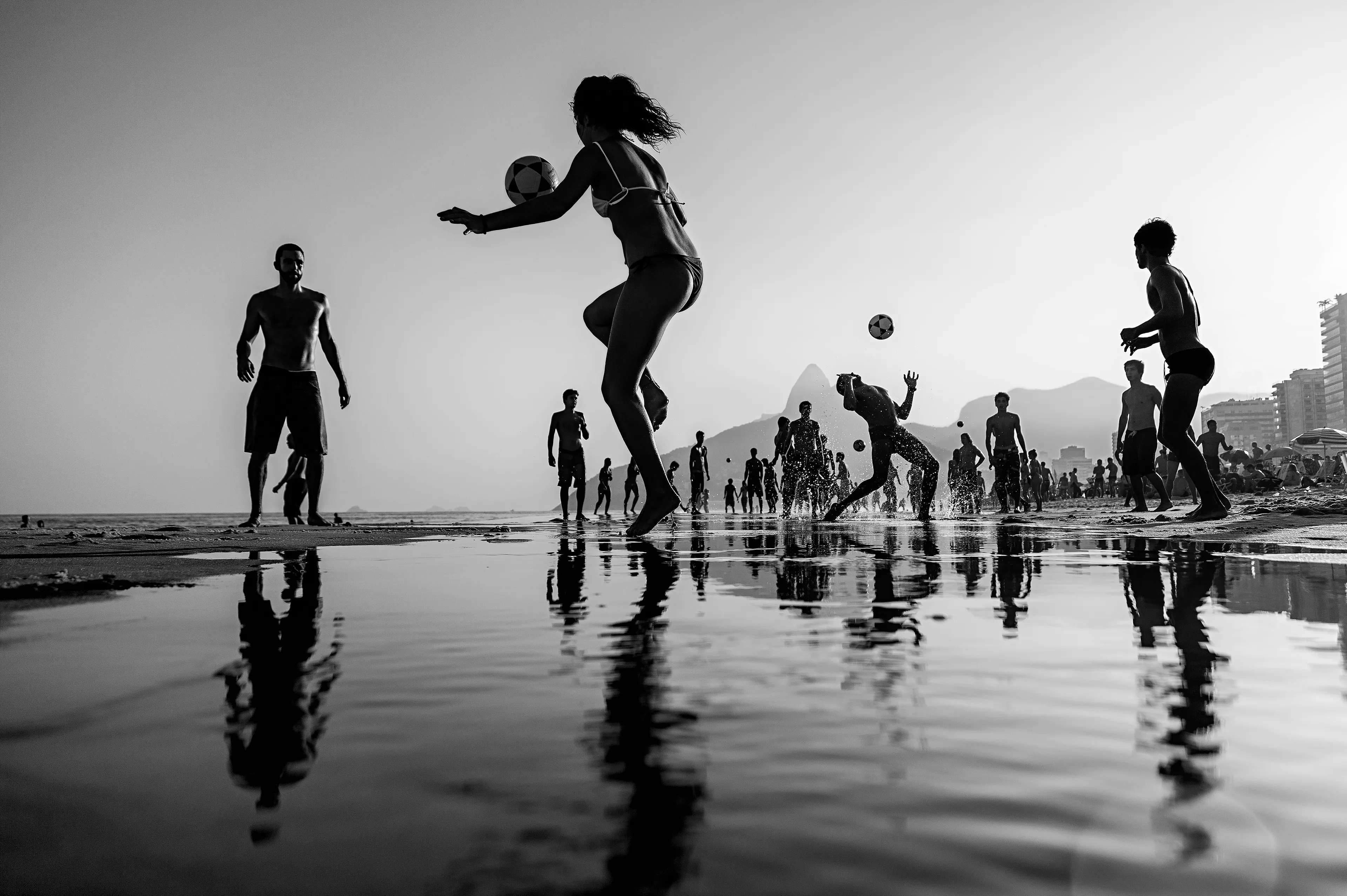 “The game” is awarded by National Geographic - Honorable Mention 2015.
It is the main and most important photograph of my career. It is in the permanent collection of the Museum of Photography in Fortaleza (One of the most important in Latin America).  
This work talks about Rio de Janeiro, about Brazil, Brazilian culture and pure joy.  
The soccer ball is a symbol of utmost importance in Brazilian society, it is democratic, fanaticism and passion.  
Women are the main protagonists. They are beautiful and in control of their own bodies and the game in the stunning scenery of Ipanema Beach. 
This is an ode to Rio de Janeiro and it’s natives, the Cariocas. 
An image that is like music, a dance, in a dizzying display of muscle and strength.  
Pure emotion!

Legendary soccer player, Pelé, called it “The Beautiful Game”, referring to the special way Brazilian players played soccer, during an interview in England, and so the expression was coined.

8268 × 5502 px

Rio de Janeiro, 2015