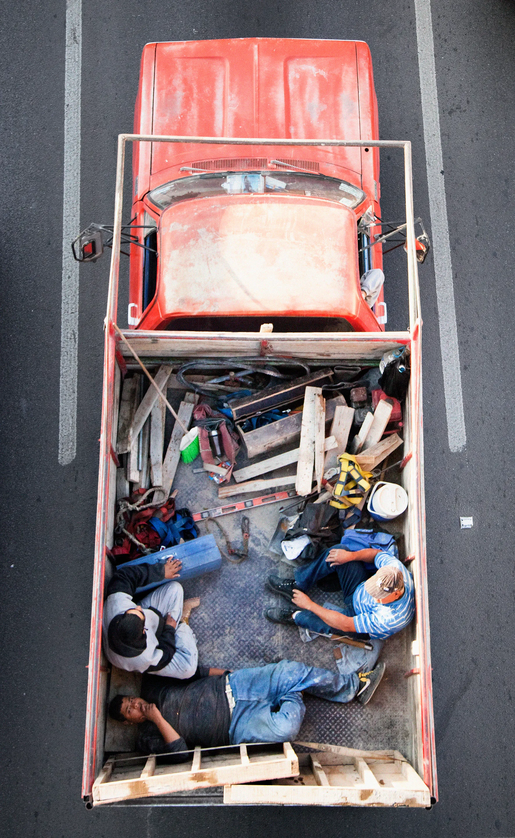 This photograph is part of my series, Carpoolers, which depicts laborers in México captured from an overpass, commuting between distant suburbs and urban centers. Like much of my work, this project comes from a desire to tell the story of the dramatic environmental, economic, and demographic changes playing out in my home city of Monterrey. This series has circulated the internet since 2011 and has been exhibited widely around the world. This piece is part of a collection of 50 works.
