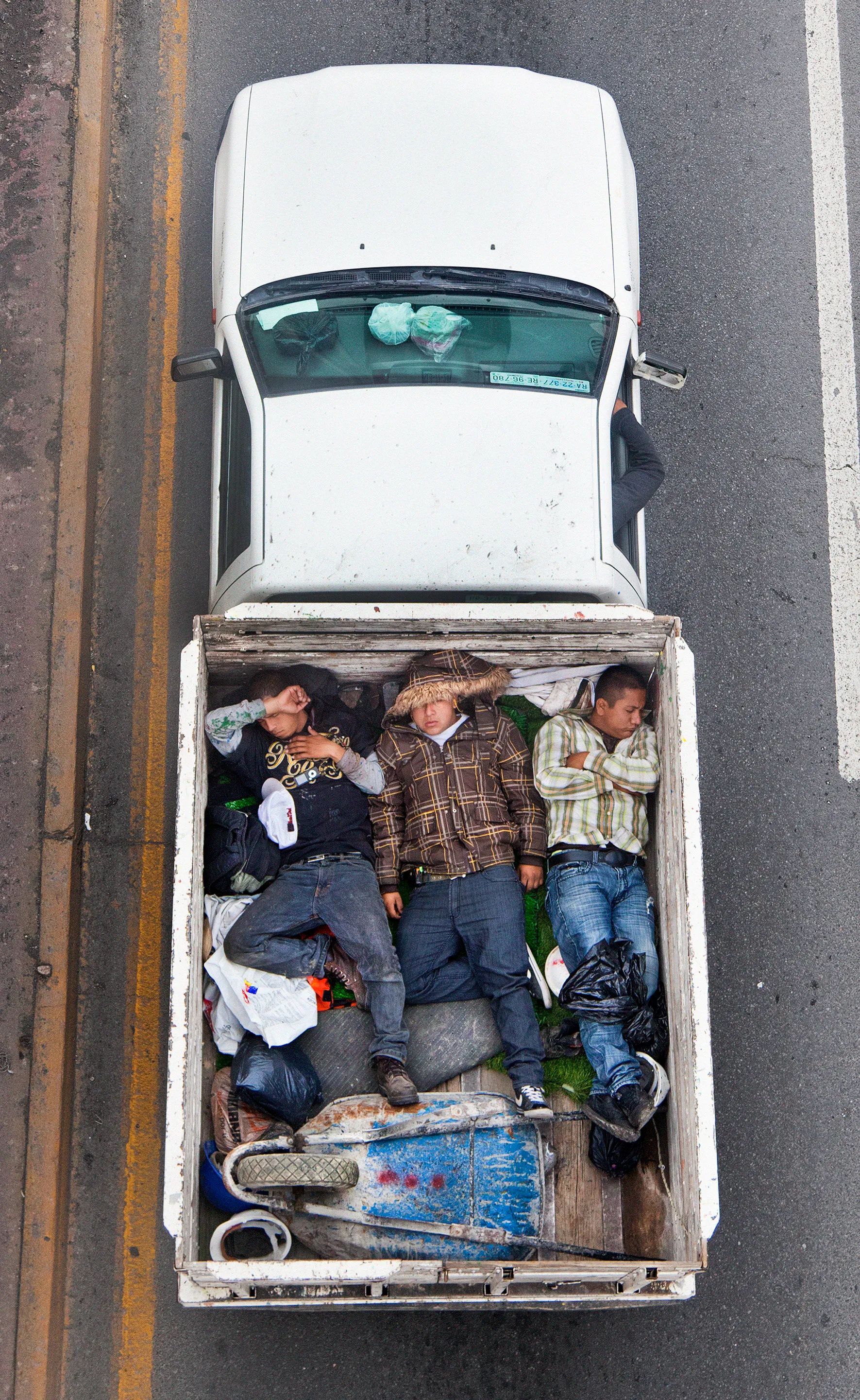 This photograph is part of my series, Carpoolers, which depicts laborers in México captured from an overpass, commuting between distant suburbs and urban centers. Like much of my work, this project comes from a desire to tell the story of the dramatic environmental, economic, and demographic changes playing out in my home city of Monterrey. This series has circulated the internet since 2011 and has been exhibited widely around the world. This piece is part of a collection of 50 works.