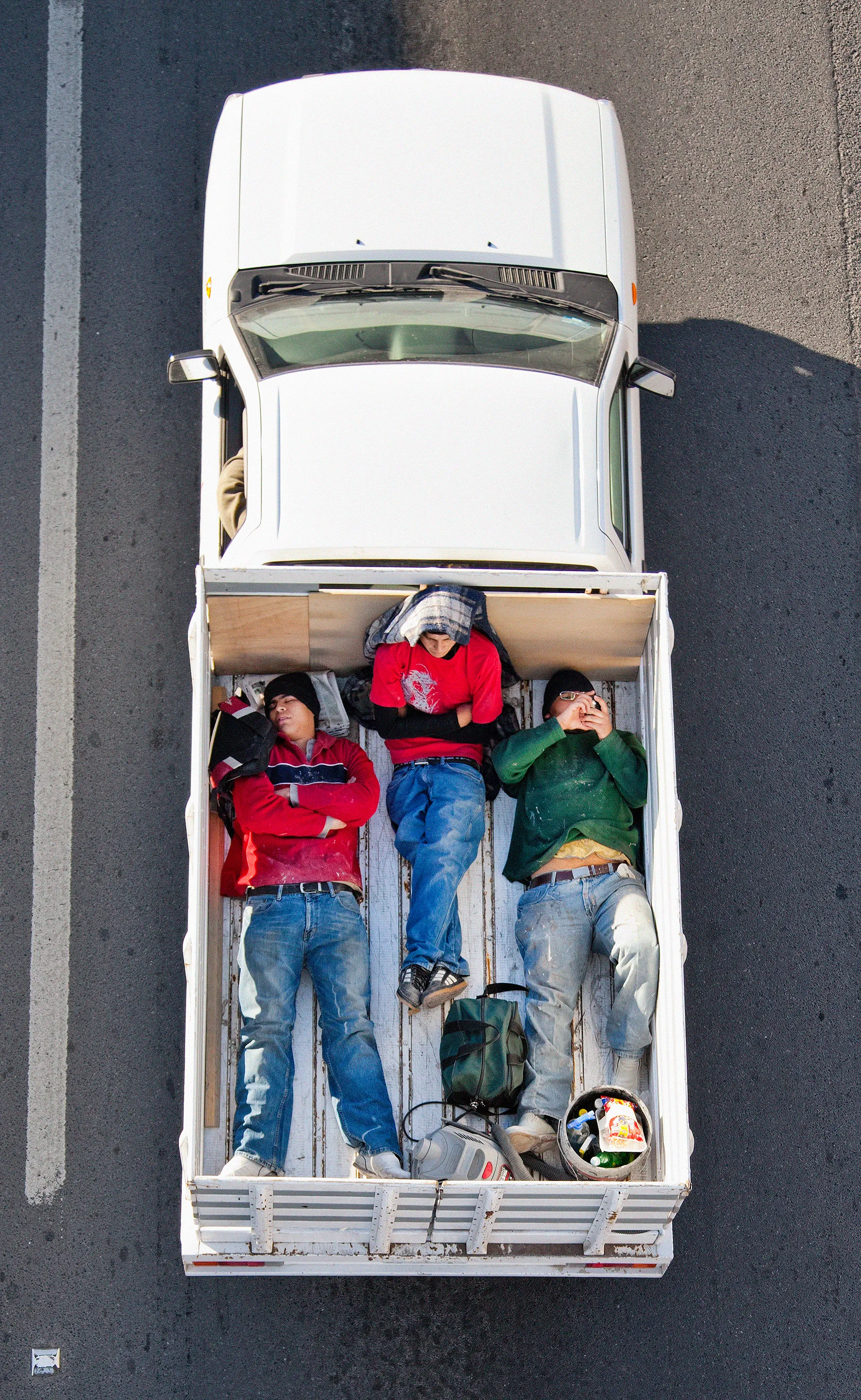 This photograph is part of my series, Carpoolers, which depicts laborers in México captured from an overpass, commuting between distant suburbs and urban centers. Like much of my work, this project comes from a desire to tell the story of the dramatic environmental, economic, and demographic changes playing out in my home city of Monterrey. This series has circulated the internet since 2011 and has been exhibited widely around the world. This piece is part of a collection of 50 works.