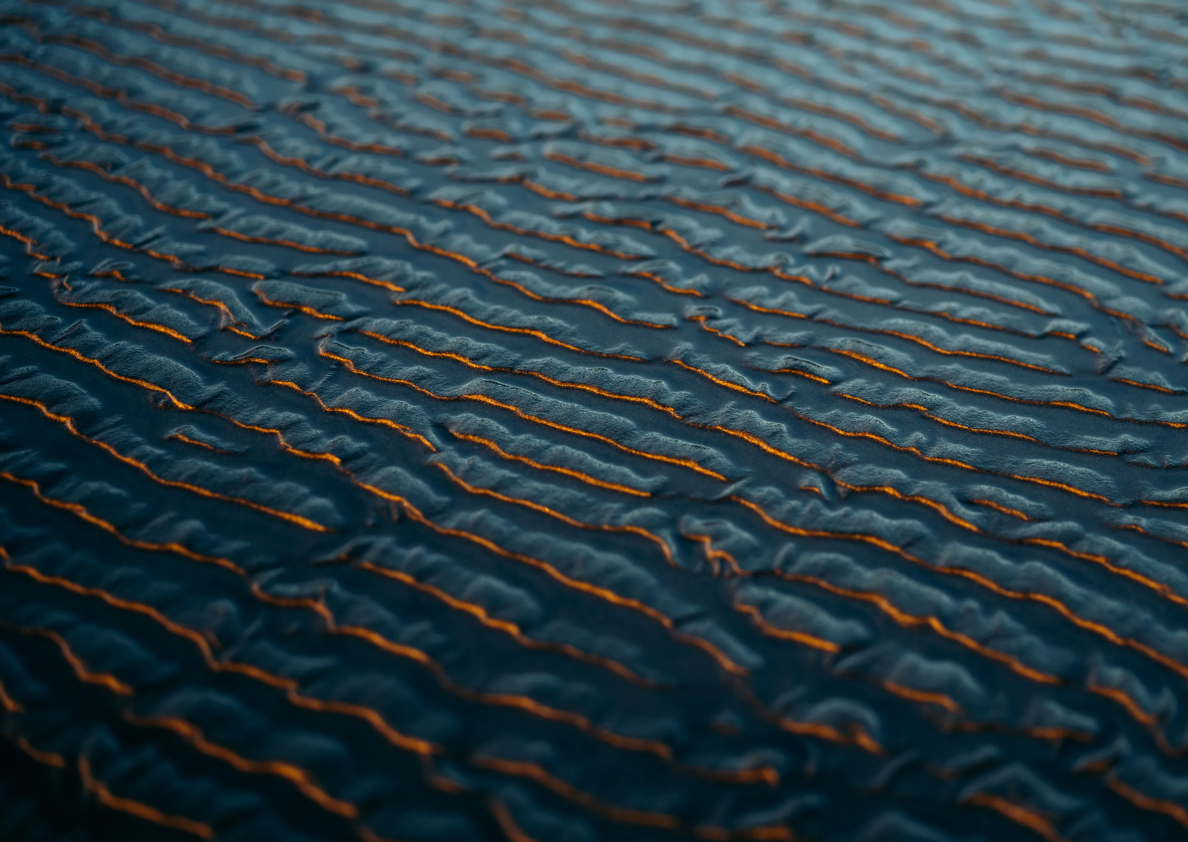 Shot on volcanic black sand, as the low winter sun bounced off ripples the tide once carved. Highlighting the cracks and therefore an important life analogy. It's so easy to get caught up skimming the surface but we can forever learn to appreciate each nook and cranny more often. Delving deeper into the roots, in order to distinguish the hobbies that aid to our overall purpose.

// 6827 x 4842px photograph captured in Anawhata, Aotearoa

Collector will receive a physical A2 Fine-Art Print.