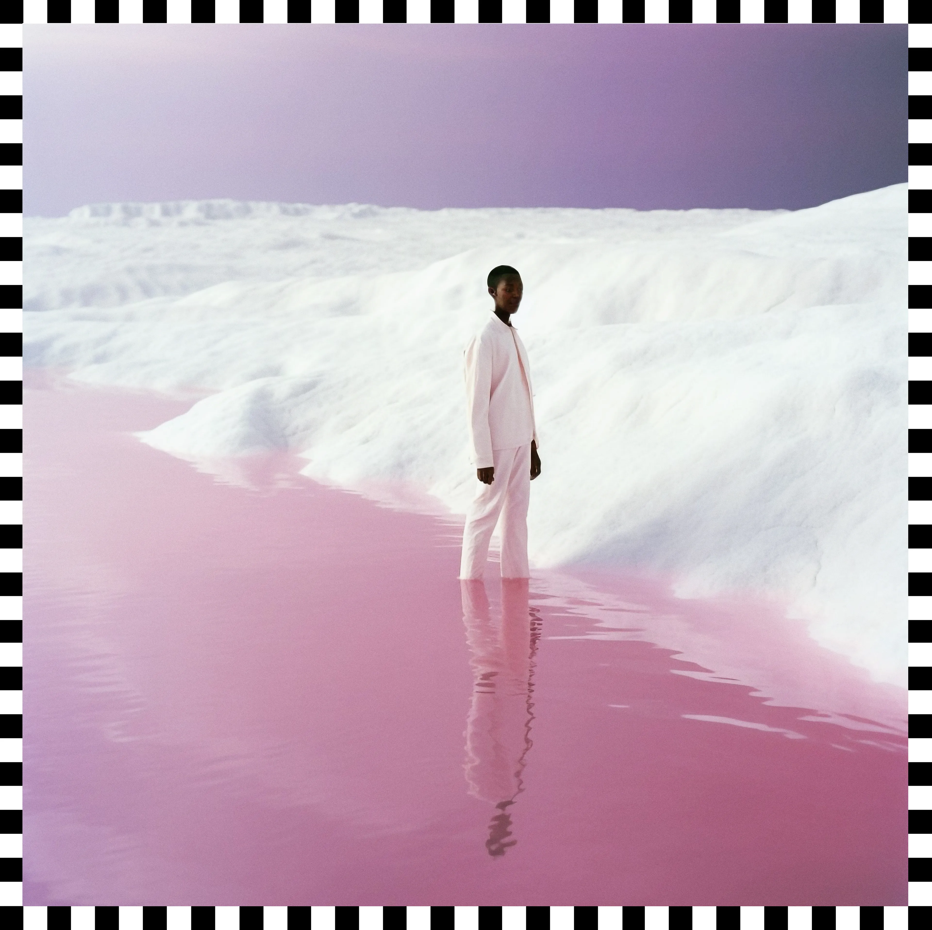 Standing amidst a melting glacier, a powerful symbol of individual action in the face of climate change. Clad in a modern pink suit, their  solitary figure underlines the imperative of individual responsibility in addressing the environmental crisis. The choice of pink as an almost monochromatic hue for the landscape signifies the specific vulnerabilities Women face in these challenges, their crucial role, and the urgent need for gender equality. The photograph, a result of cutting-edge technology and a decade-long personal work, underscores the powerful impact each individual can have in the global fight against climate change.